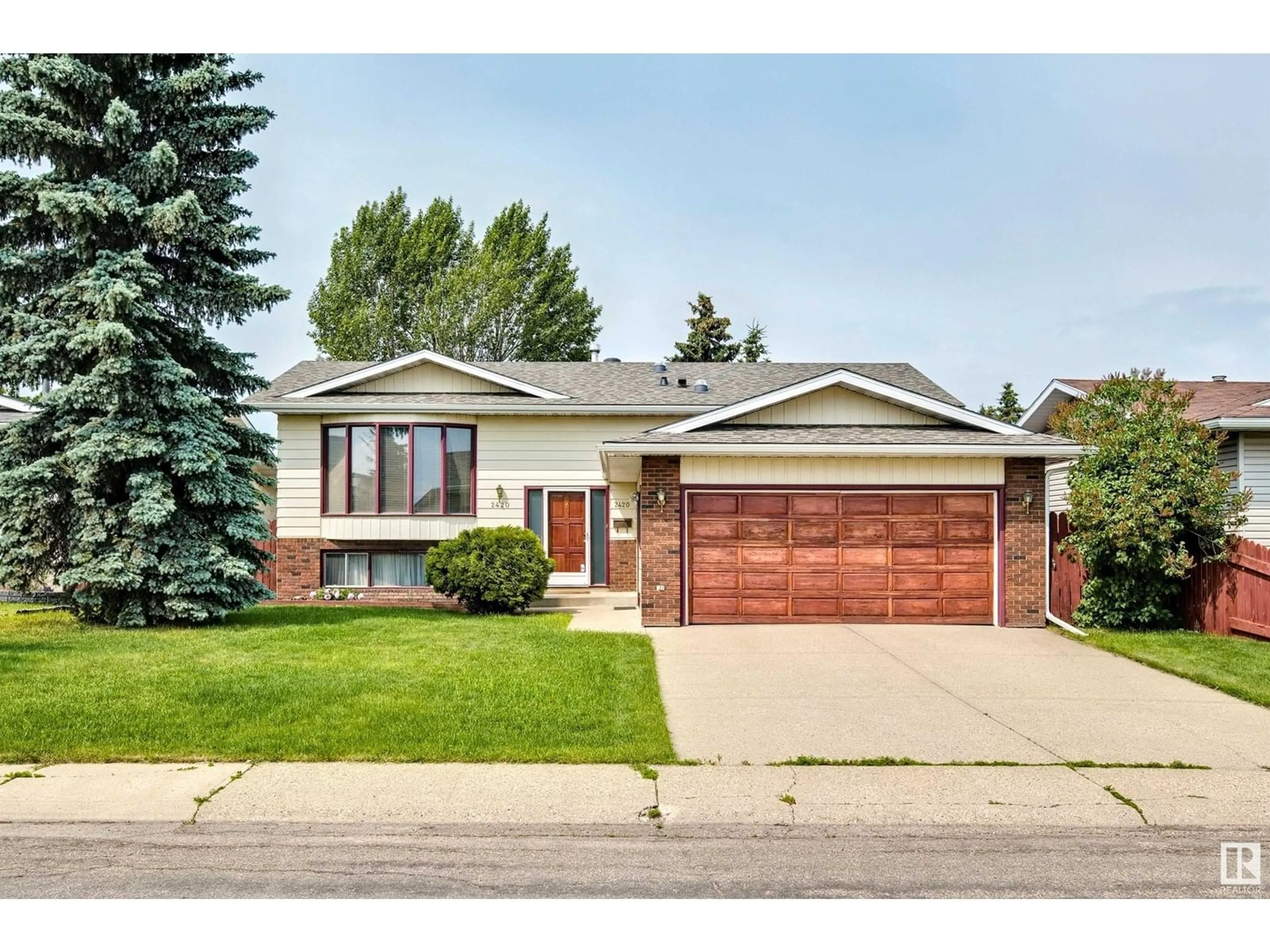 Home with brick exterior material, street for 2420 78 ST, Edmonton Alberta T6K3W4