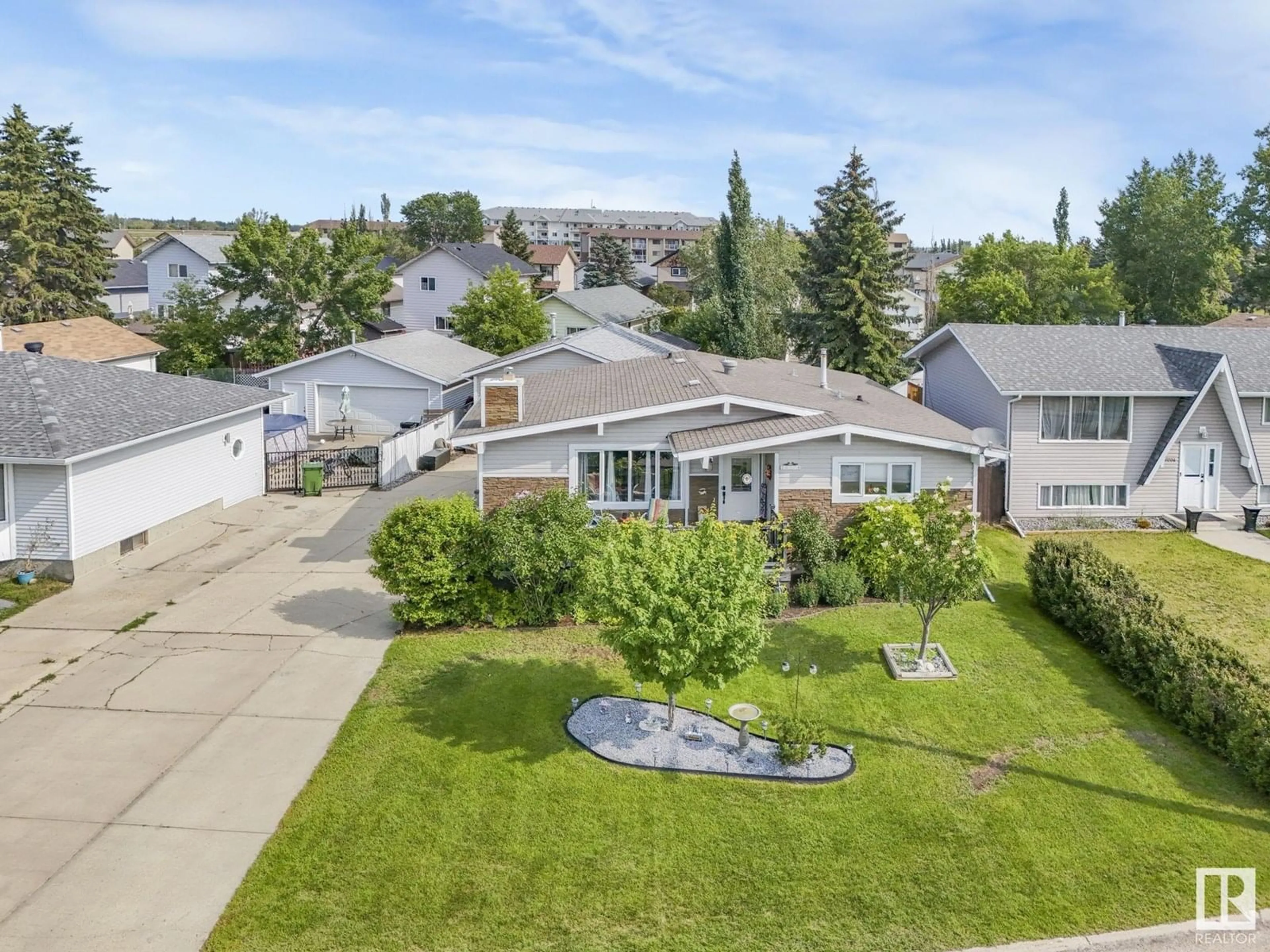 A pic from outside/outdoor area/front of a property/back of a property/a pic from drone, street for 10706 97 AV, Morinville Alberta T8R1E3