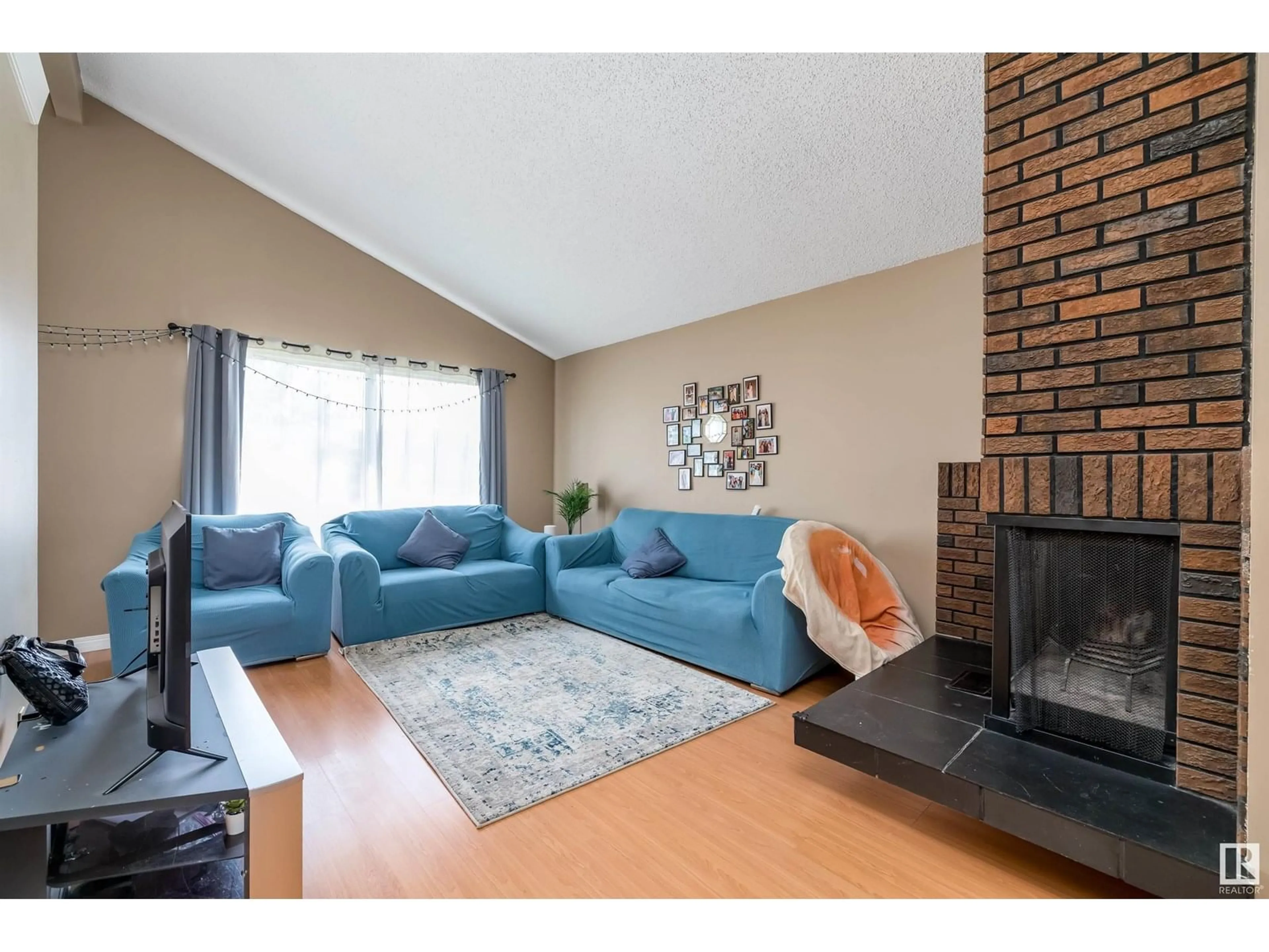 Living room with furniture, wood/laminate floor for 3620 42A AVE, Edmonton Alberta T6L4N7