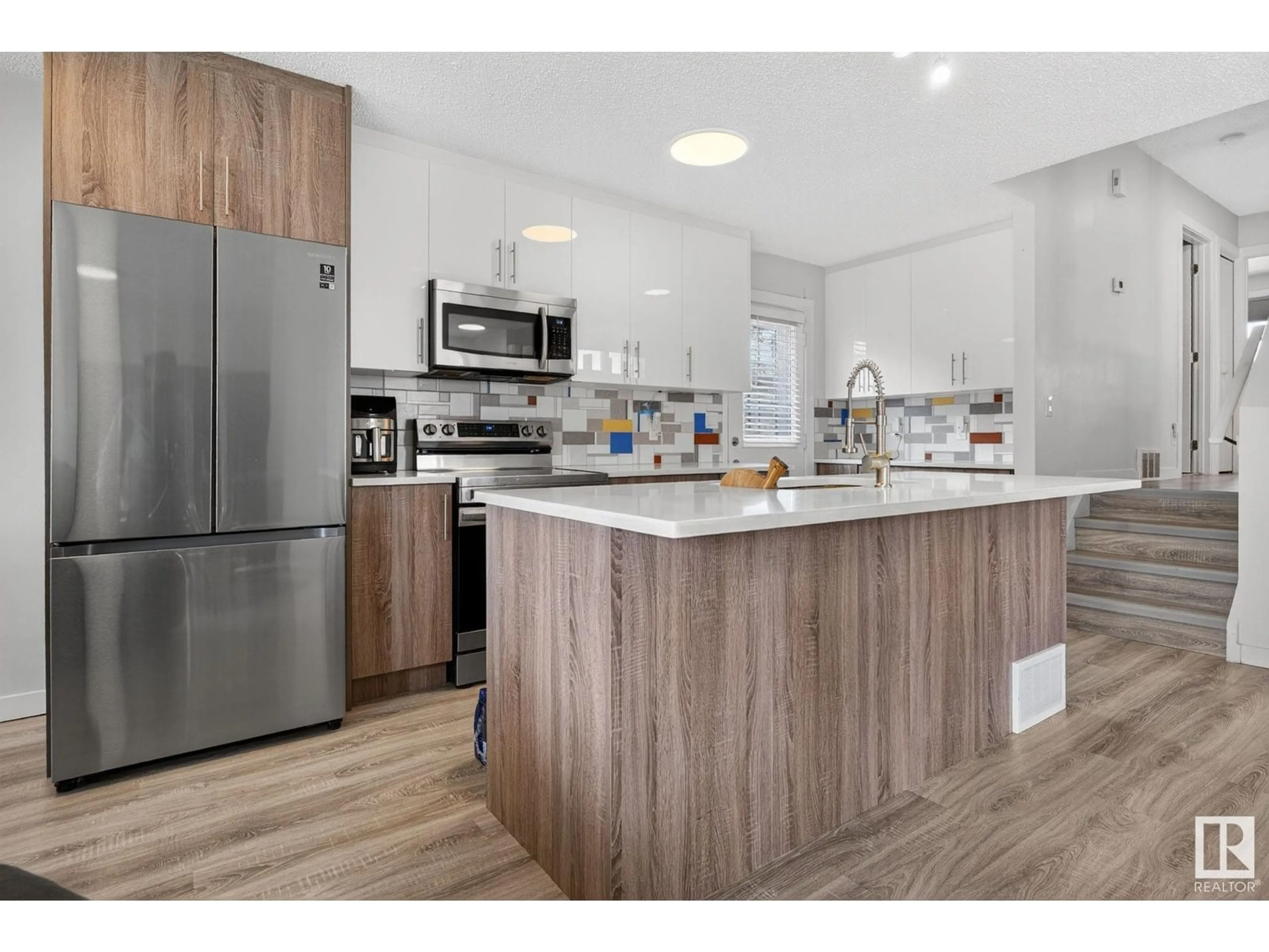 Open concept kitchen, wood/laminate floor for 17316 94A AV, Edmonton Alberta T5T4H2