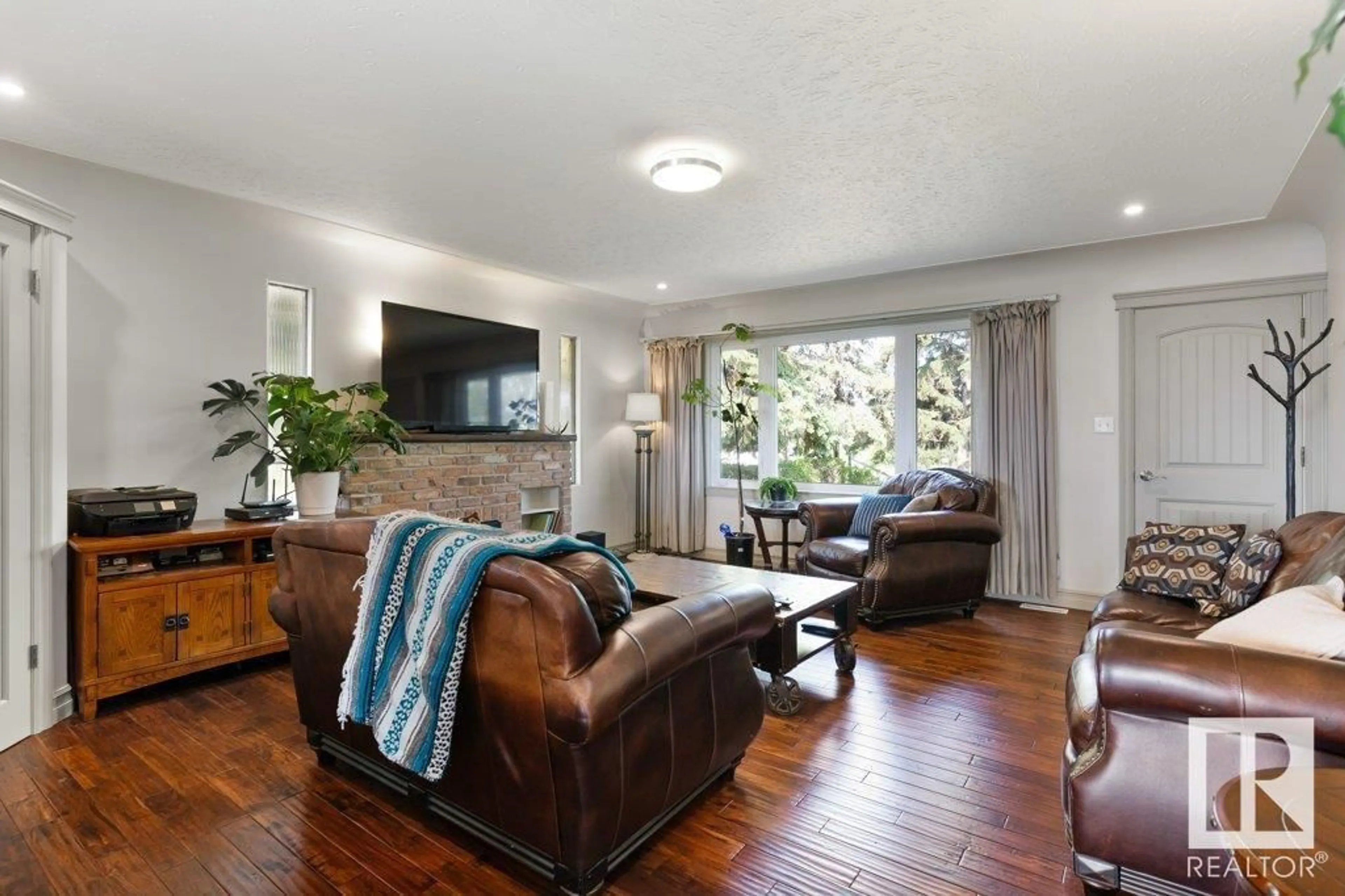 Living room with furniture, wood/laminate floor for 55360 RGE ROAD 205, Rural Strathcona County Alberta T8L4B1