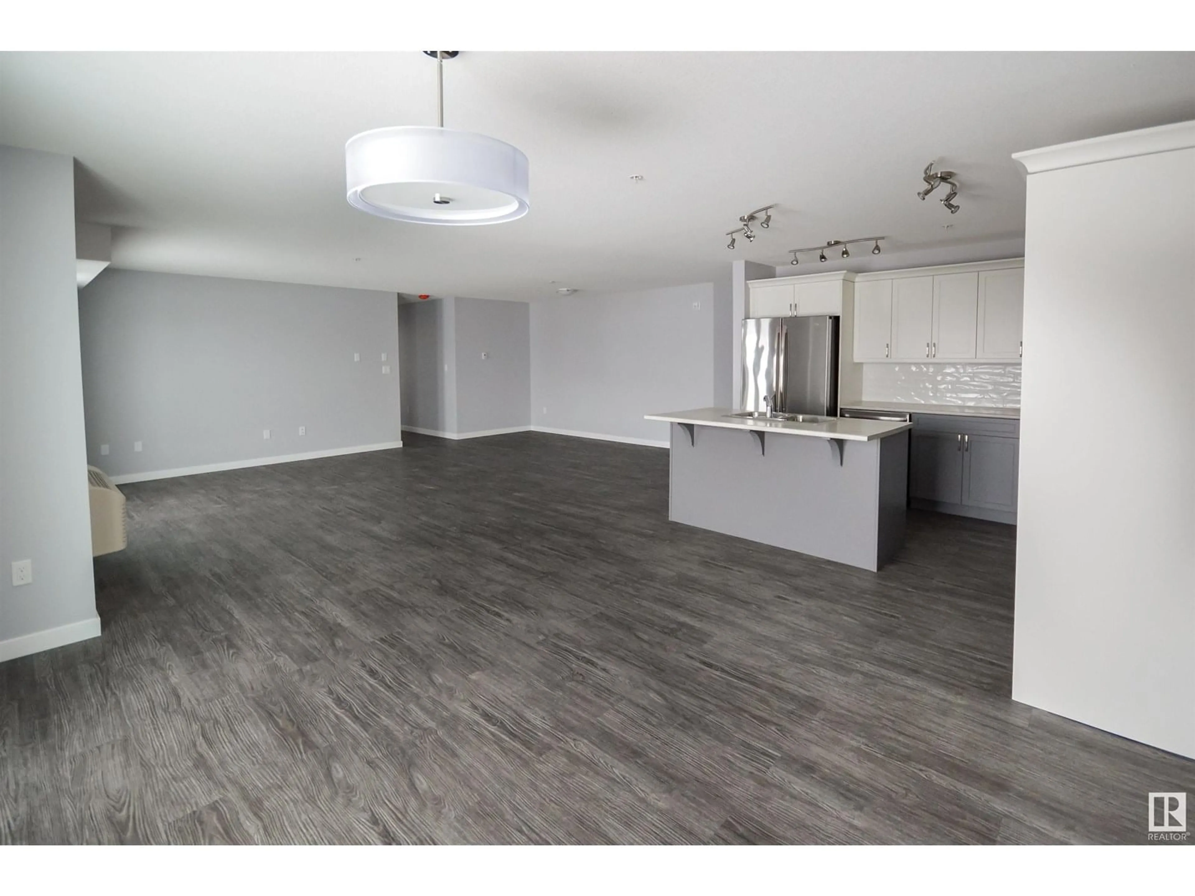 Open concept kitchen, wood/laminate floor for #102 - 4110 43 AV, Bonnyville Town Alberta T9N1S8