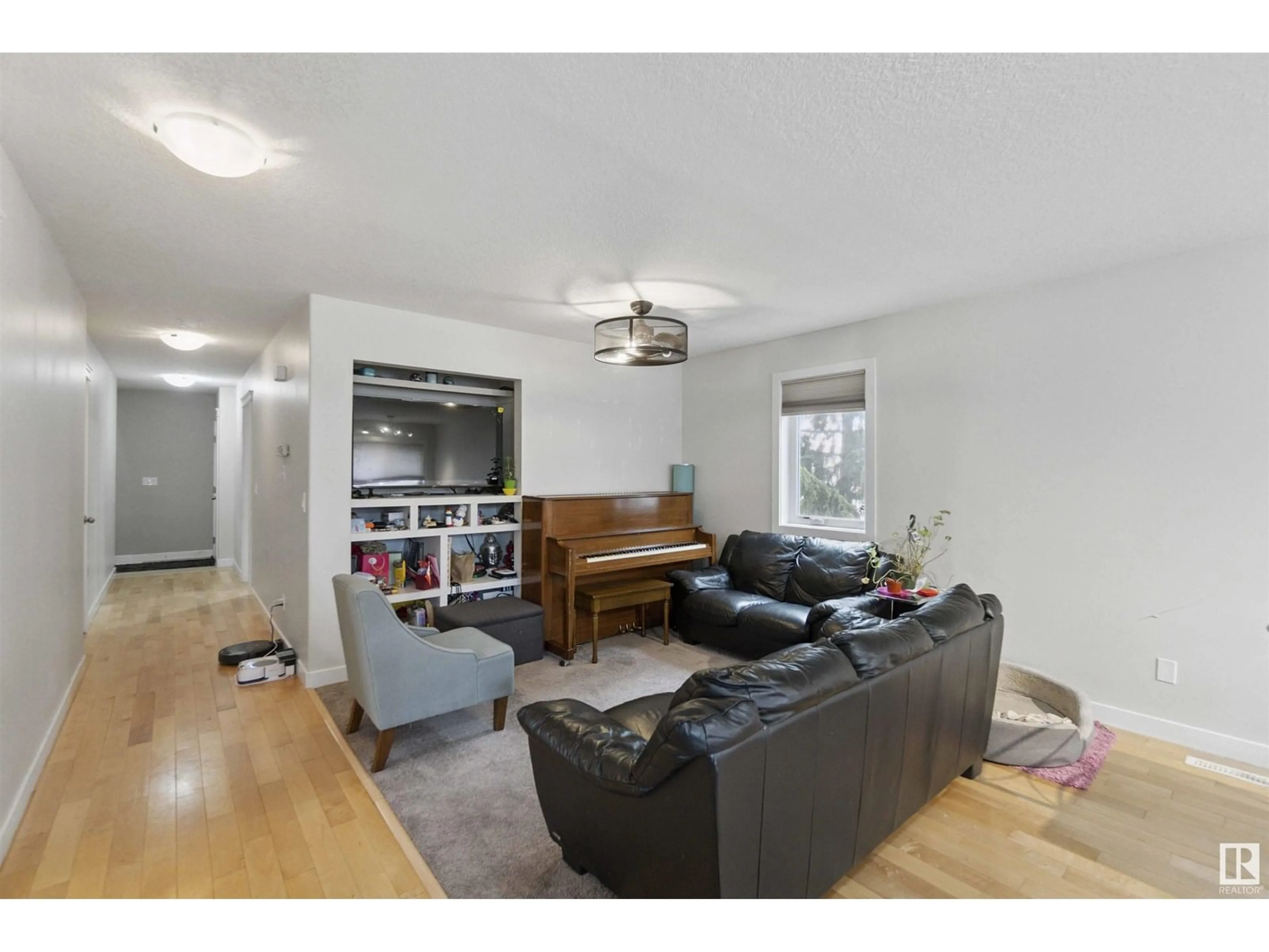 Living room with furniture, wood/laminate floor for NW - 11438 97 ST, Edmonton Alberta T5X1X5