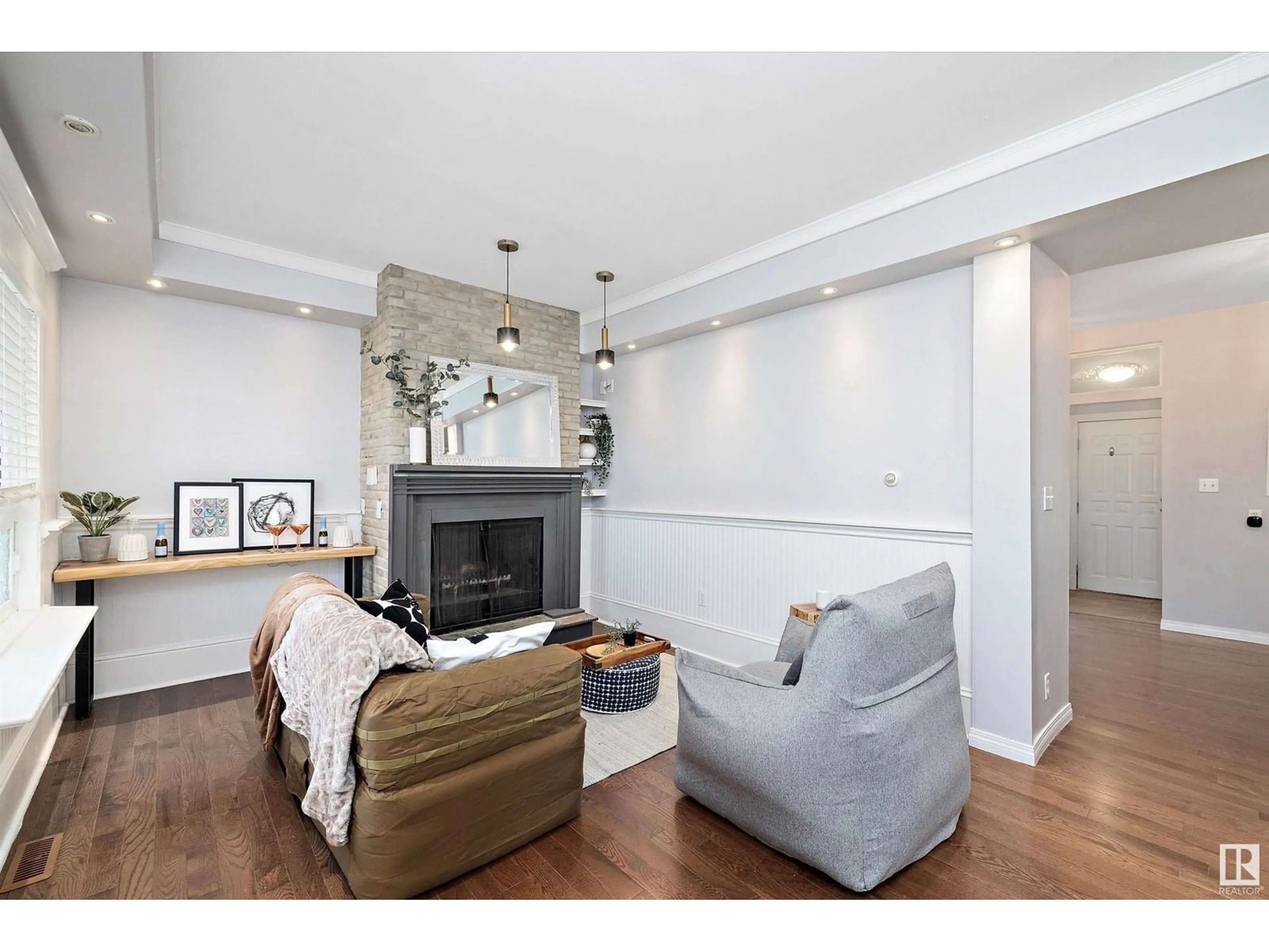 Living room with furniture, wood/laminate floor for 8702 92A AV, Edmonton Alberta T6C1S6