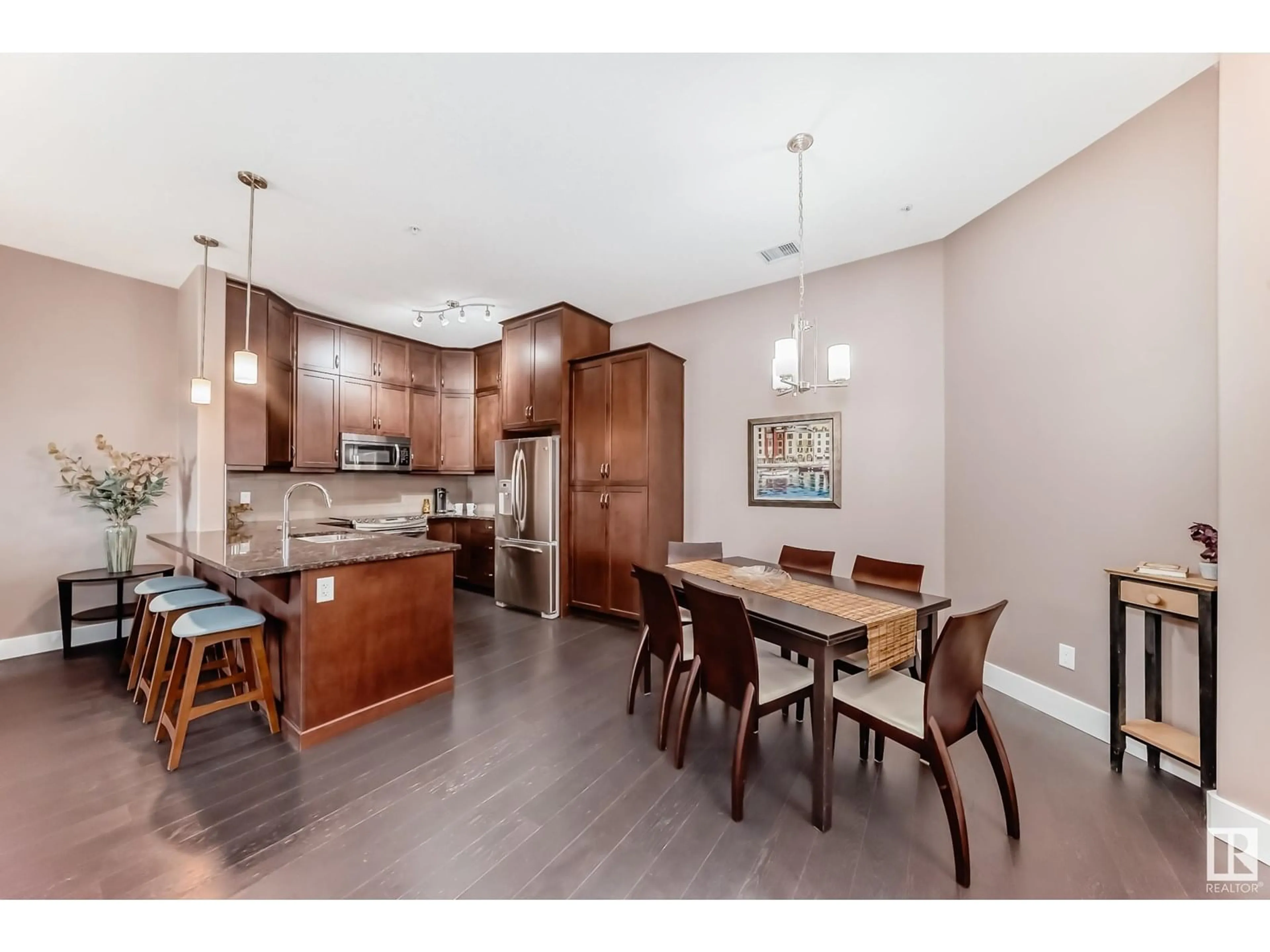 Open concept kitchen, wood/laminate floor for #434 - 6079 MAYNARD WY, Edmonton Alberta T6R0S4