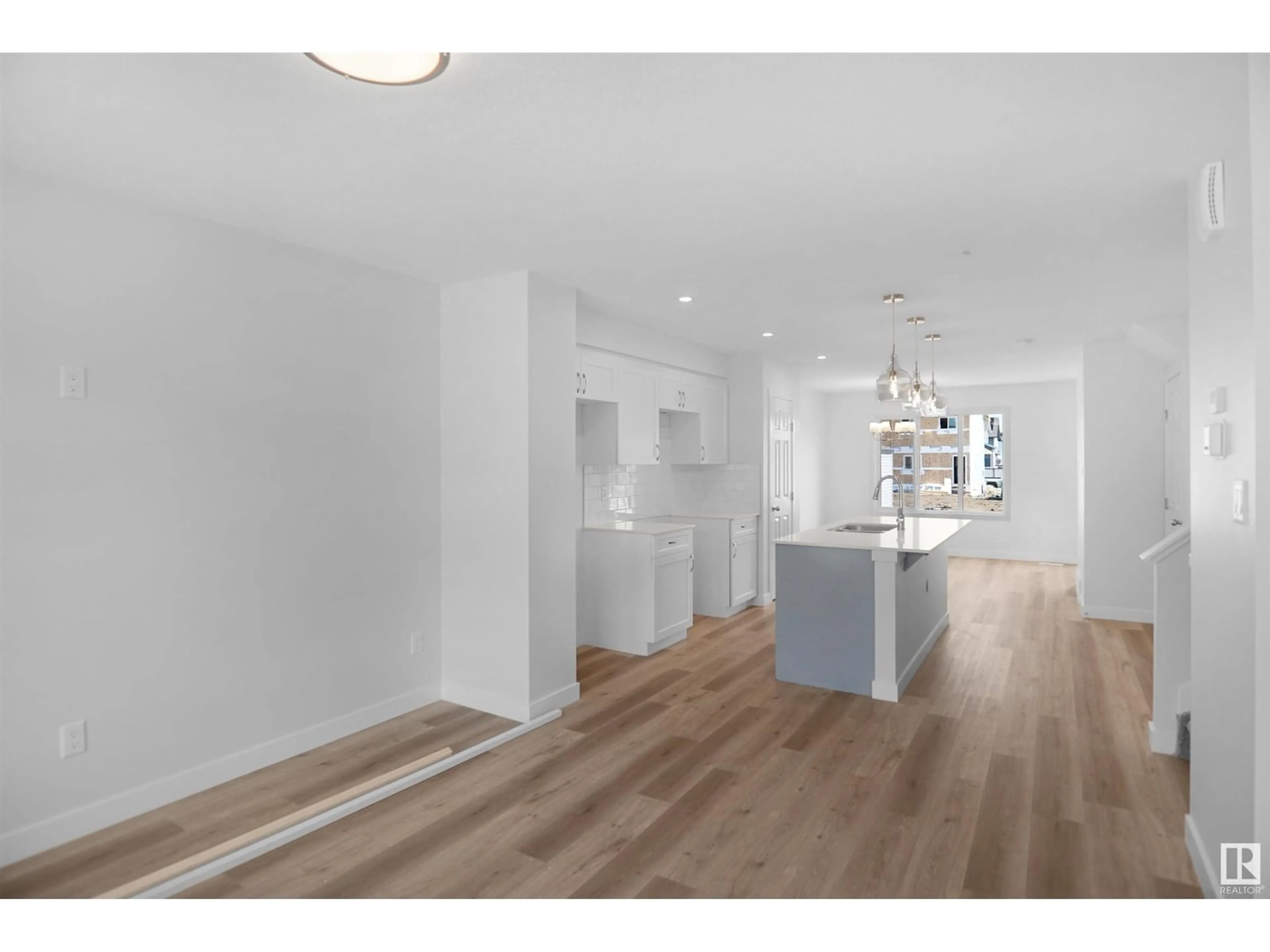 Open concept kitchen, wood/laminate floor for 20919 16 AV, Edmonton Alberta T6M1L2