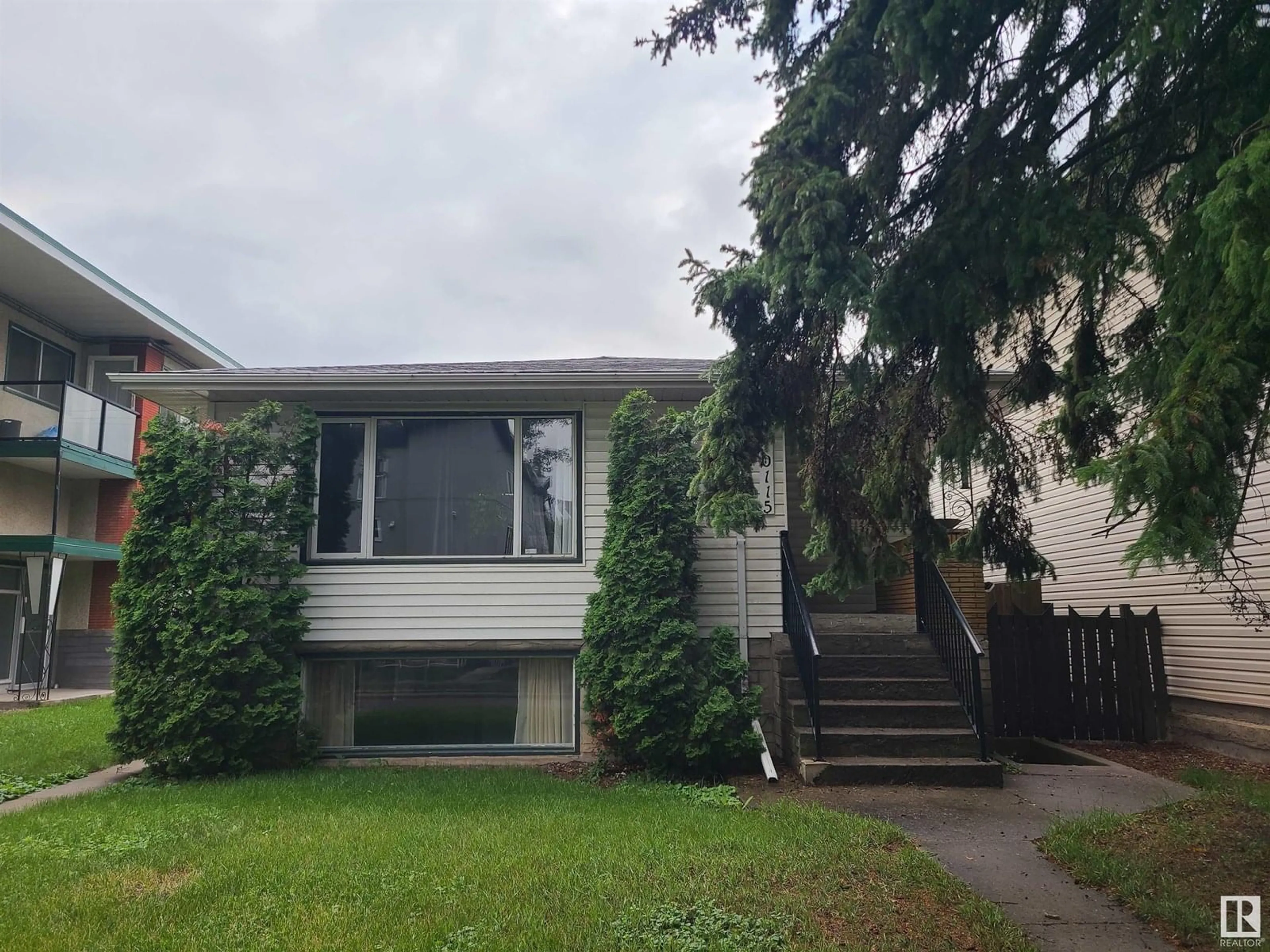 Home with vinyl exterior material, street for 10115 83 AV, Edmonton Alberta T6E2C5