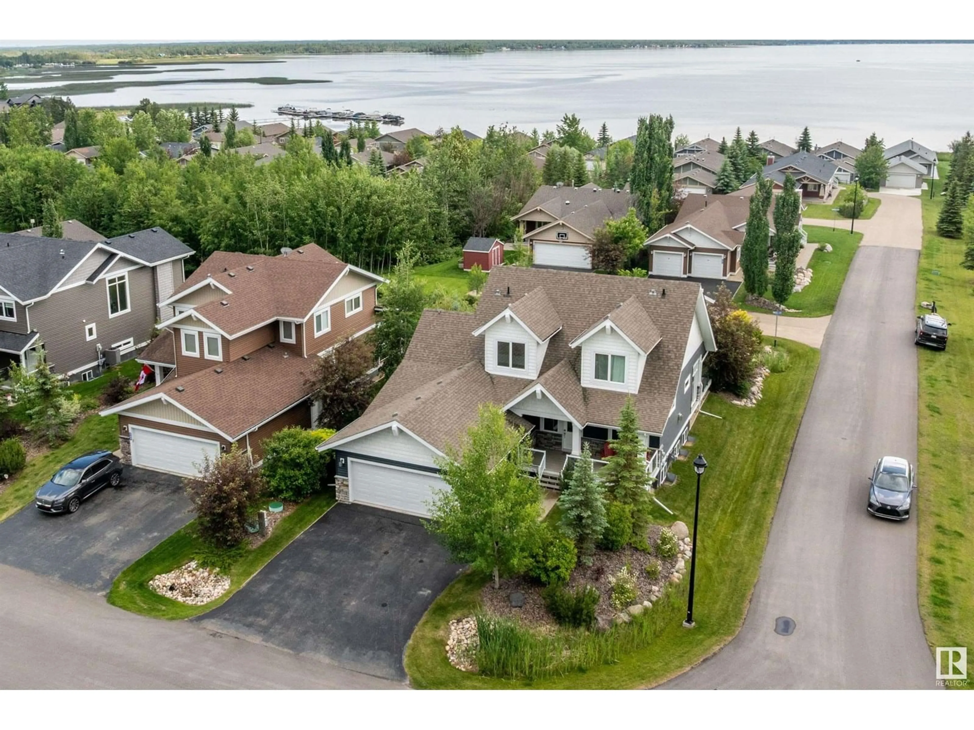 A pic from outside/outdoor area/front of a property/back of a property/a pic from drone, water/lake/river/ocean view for 55101 STE. ANNE TR, Rural Lac Ste. Anne County Alberta T0E1A1