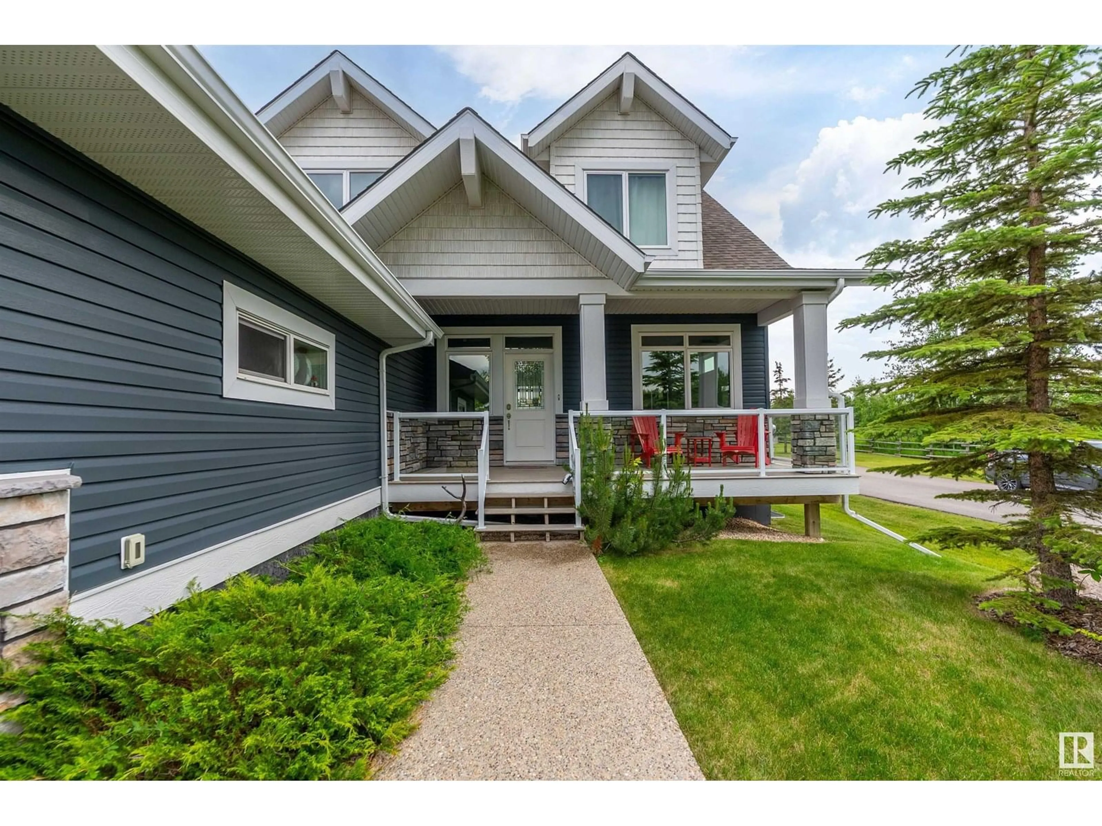 Home with vinyl exterior material, street for 55101 STE. ANNE TR, Rural Lac Ste. Anne County Alberta T0E1A1