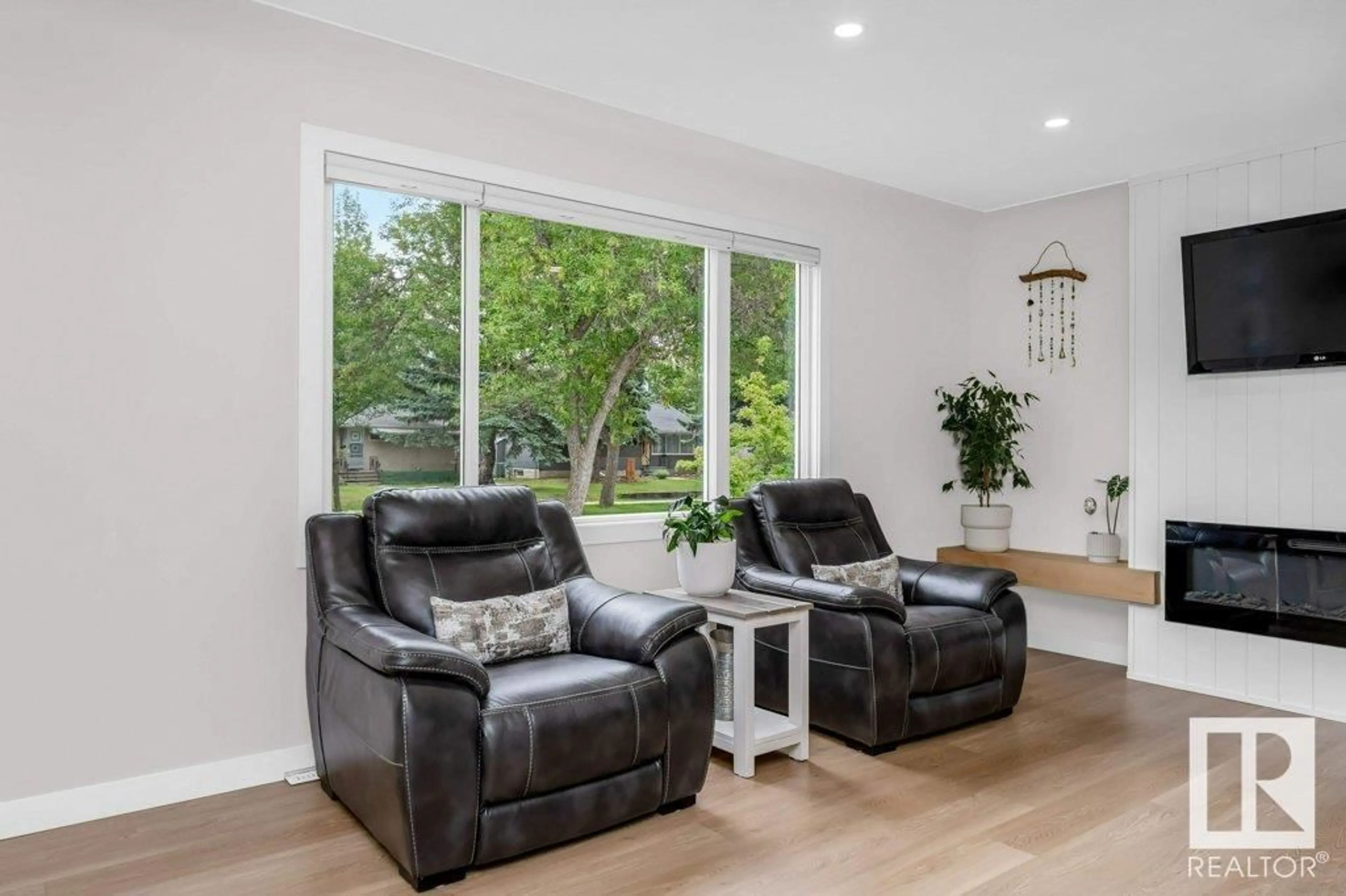 Living room with furniture, wood/laminate floor for 12244 135 ST, Edmonton Alberta T5L1X1