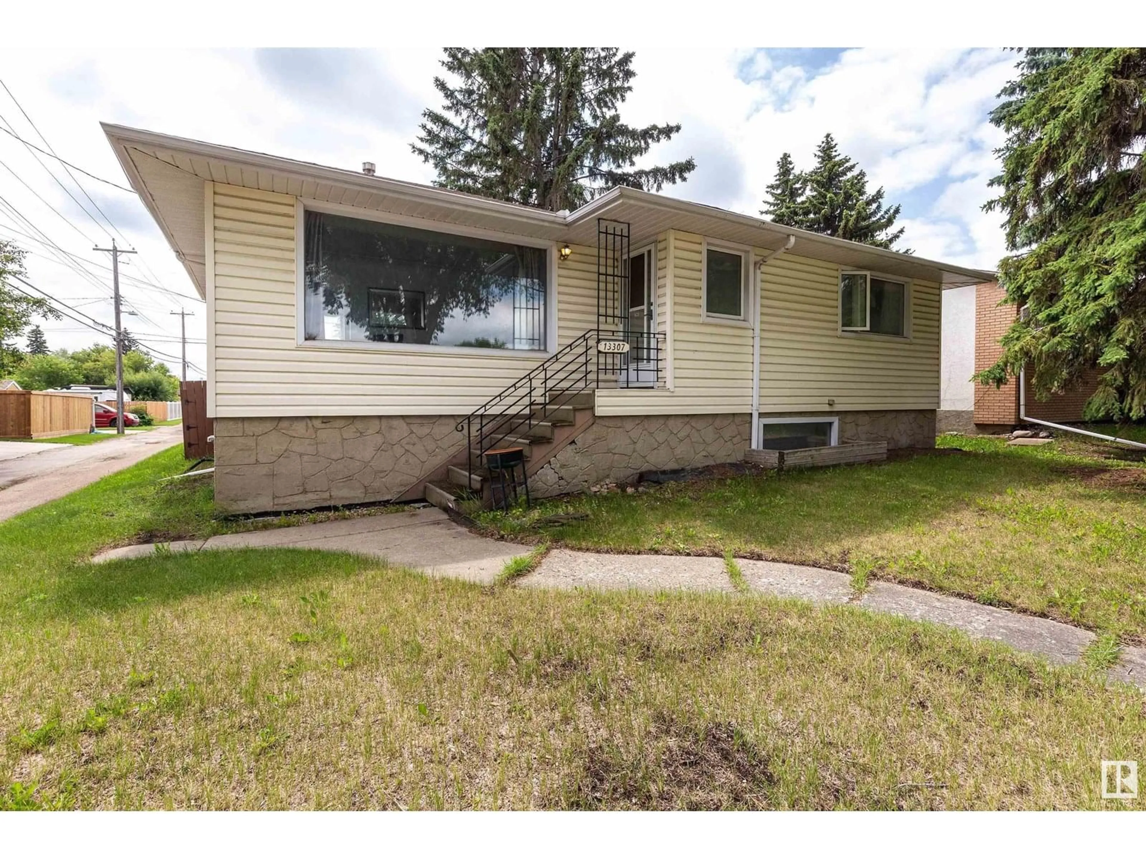 Home with vinyl exterior material, street for 13307 116 AV, Edmonton Alberta T5M3E4