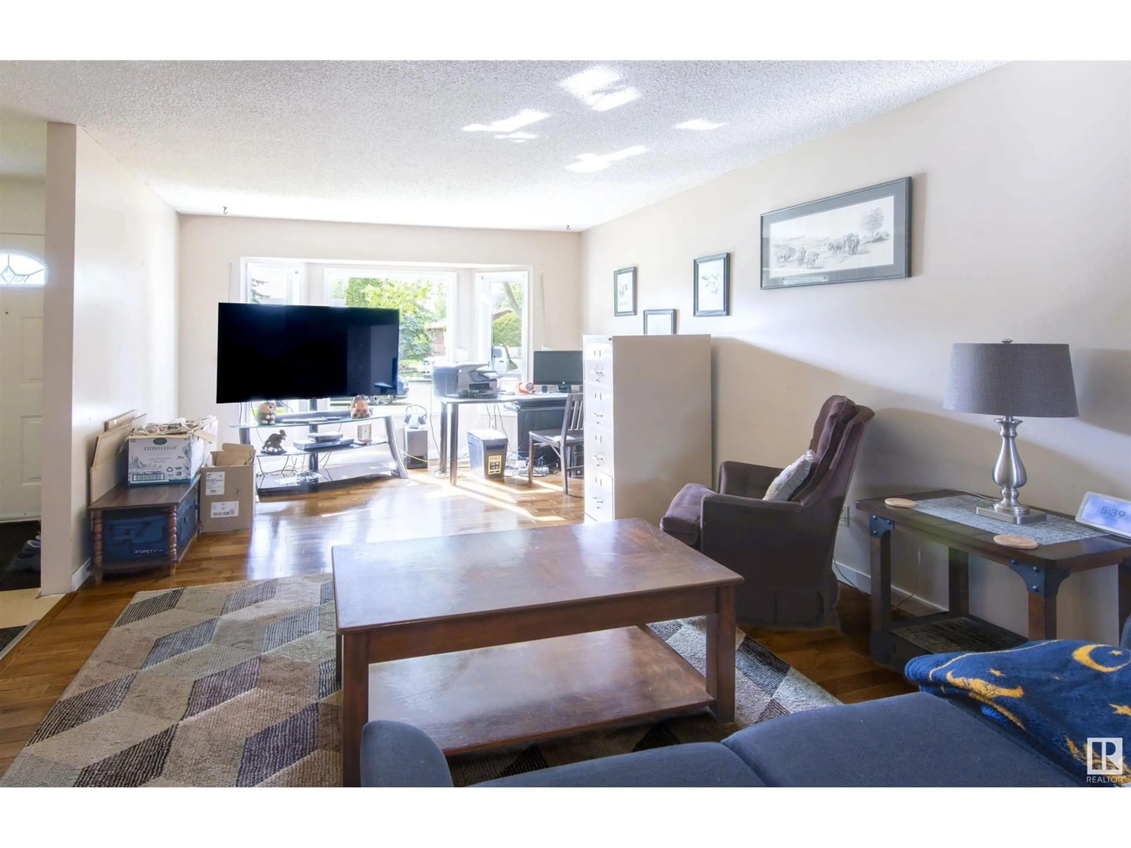 Living room with furniture, wood/laminate floor for 3959 55 ST, Edmonton Alberta T6L1C1