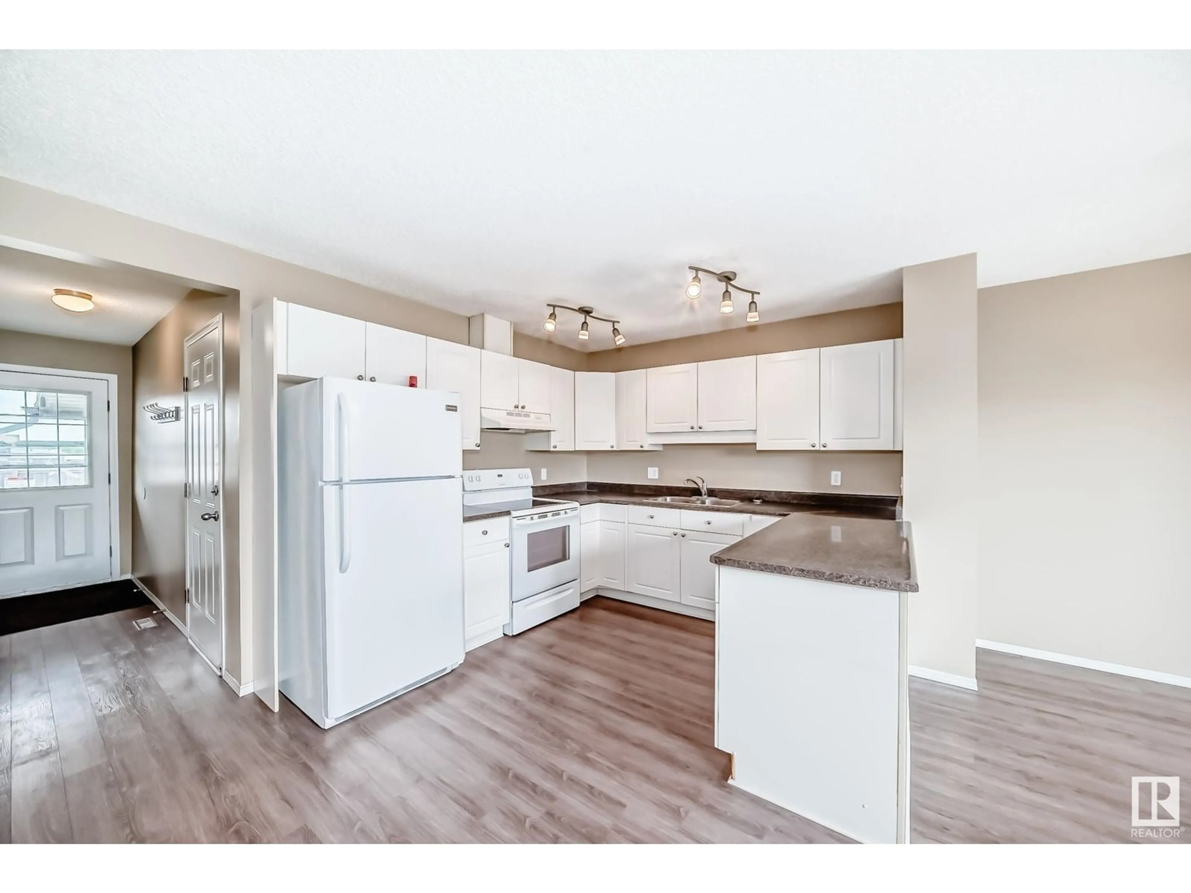 Open concept kitchen, wood/laminate floor for 3018 30 AV, Edmonton Alberta T6T1V2
