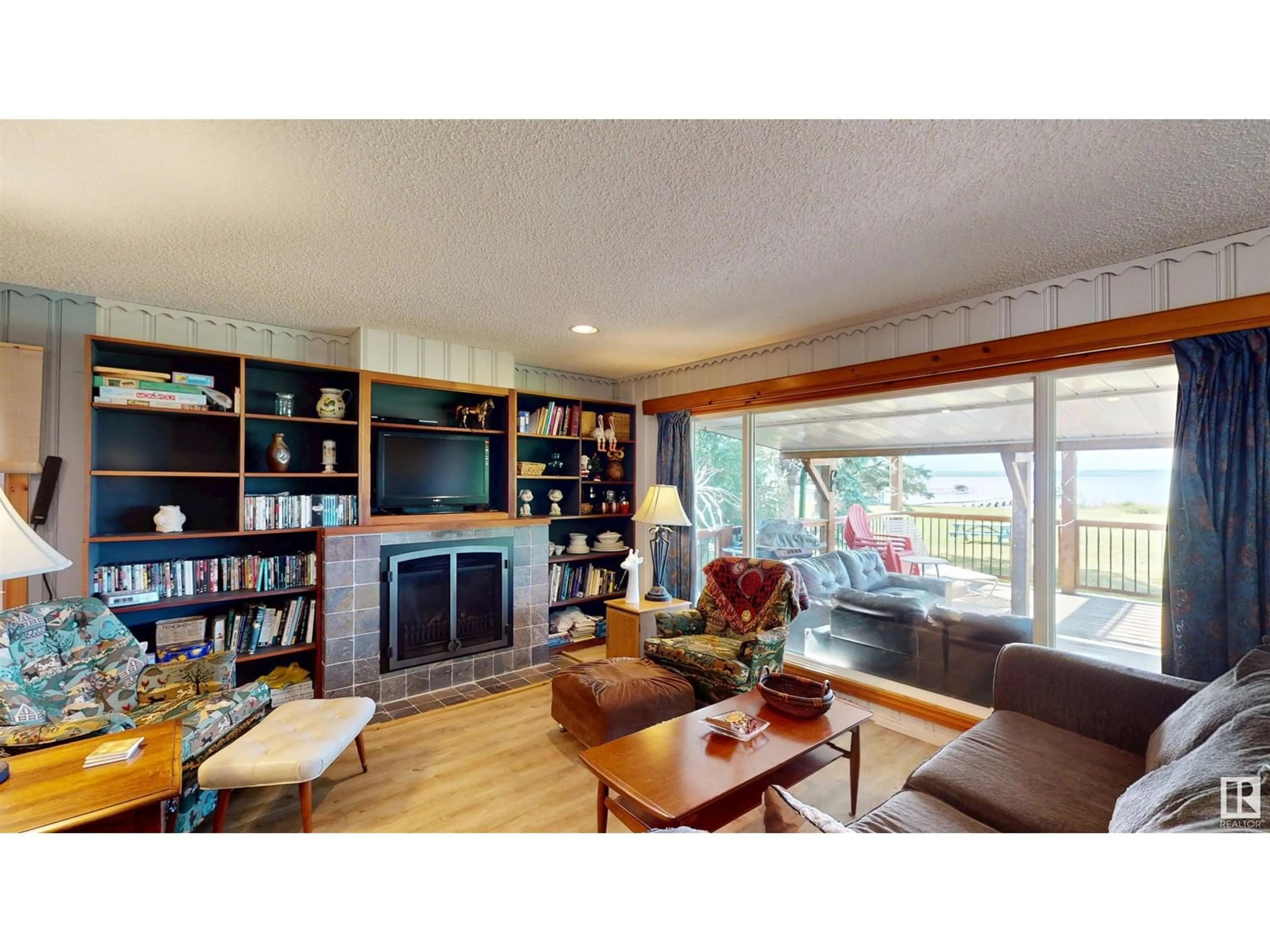 Living room with furniture, wood/laminate floor for 53026 - 12 RGE ROAD 43, Rural Parkland County Alberta T0E2K0