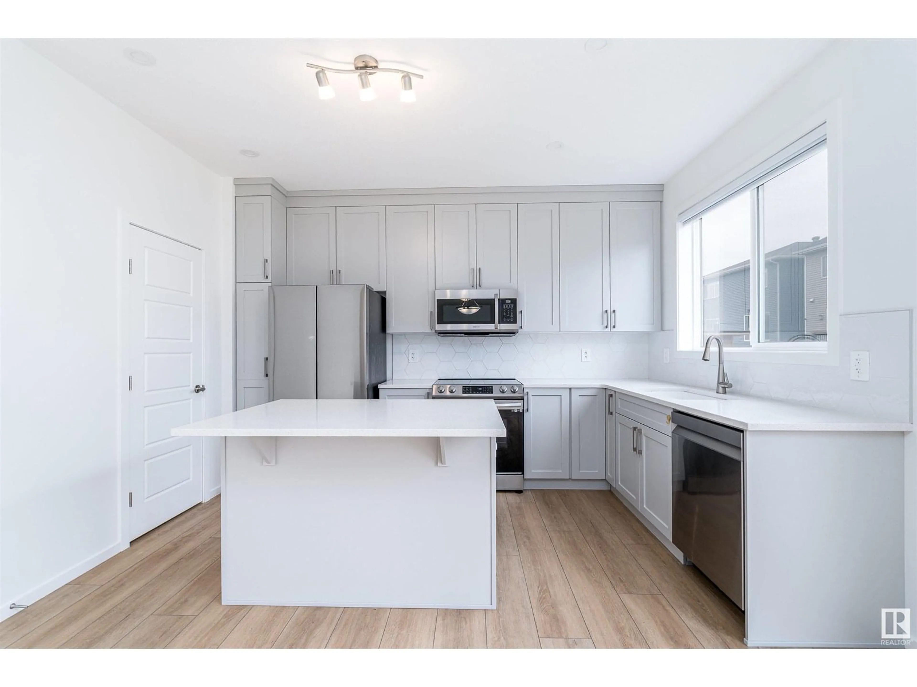 Open concept kitchen, wood/laminate floor for 20614 19A AV, Edmonton Alberta T6M1R6