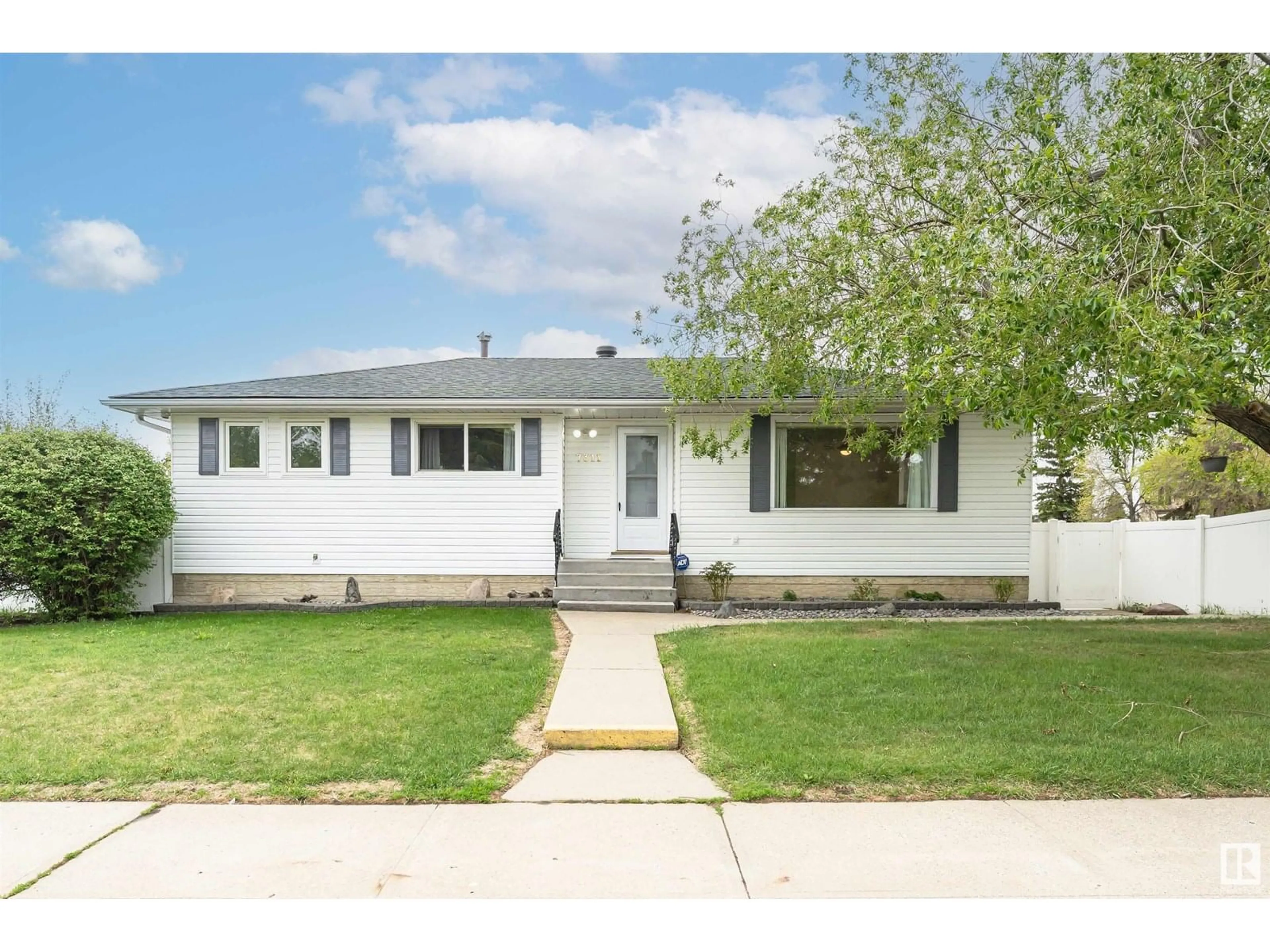 Home with vinyl exterior material, street for 7311 138 AV, Edmonton Alberta T5C2L9