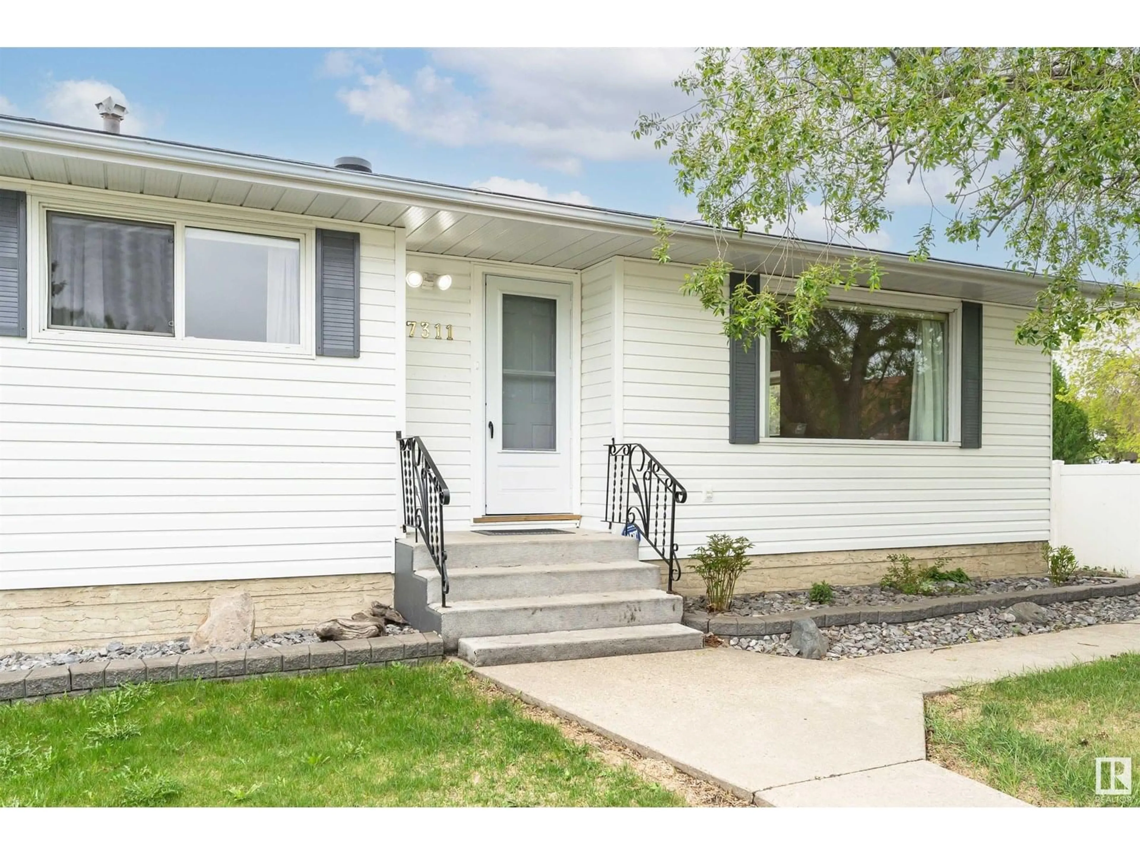Home with vinyl exterior material, street for 7311 138 AV, Edmonton Alberta T5C2L9