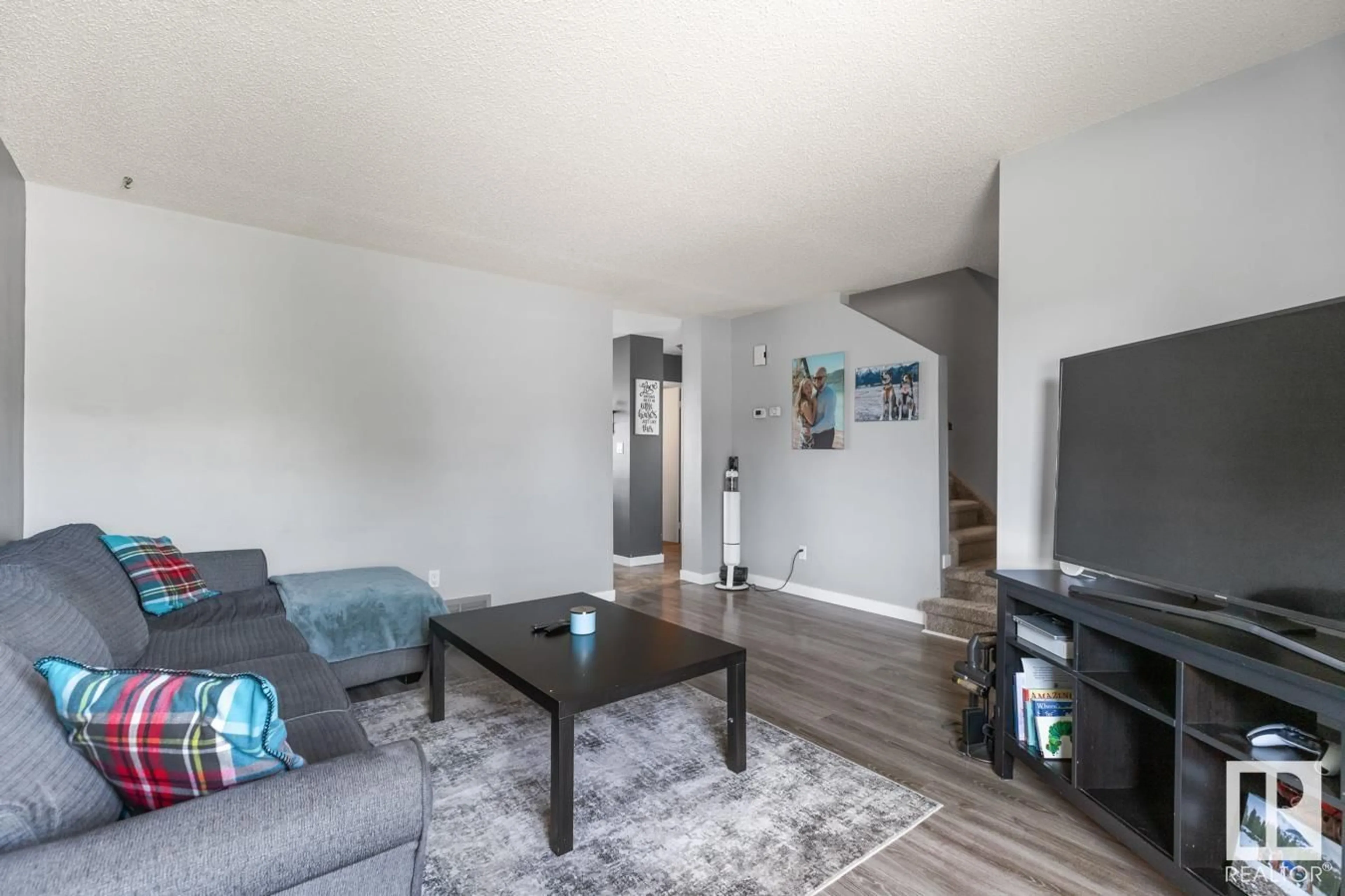 Living room with furniture, wood/laminate floor for 4703 32 AV, Edmonton Alberta T6L5J4