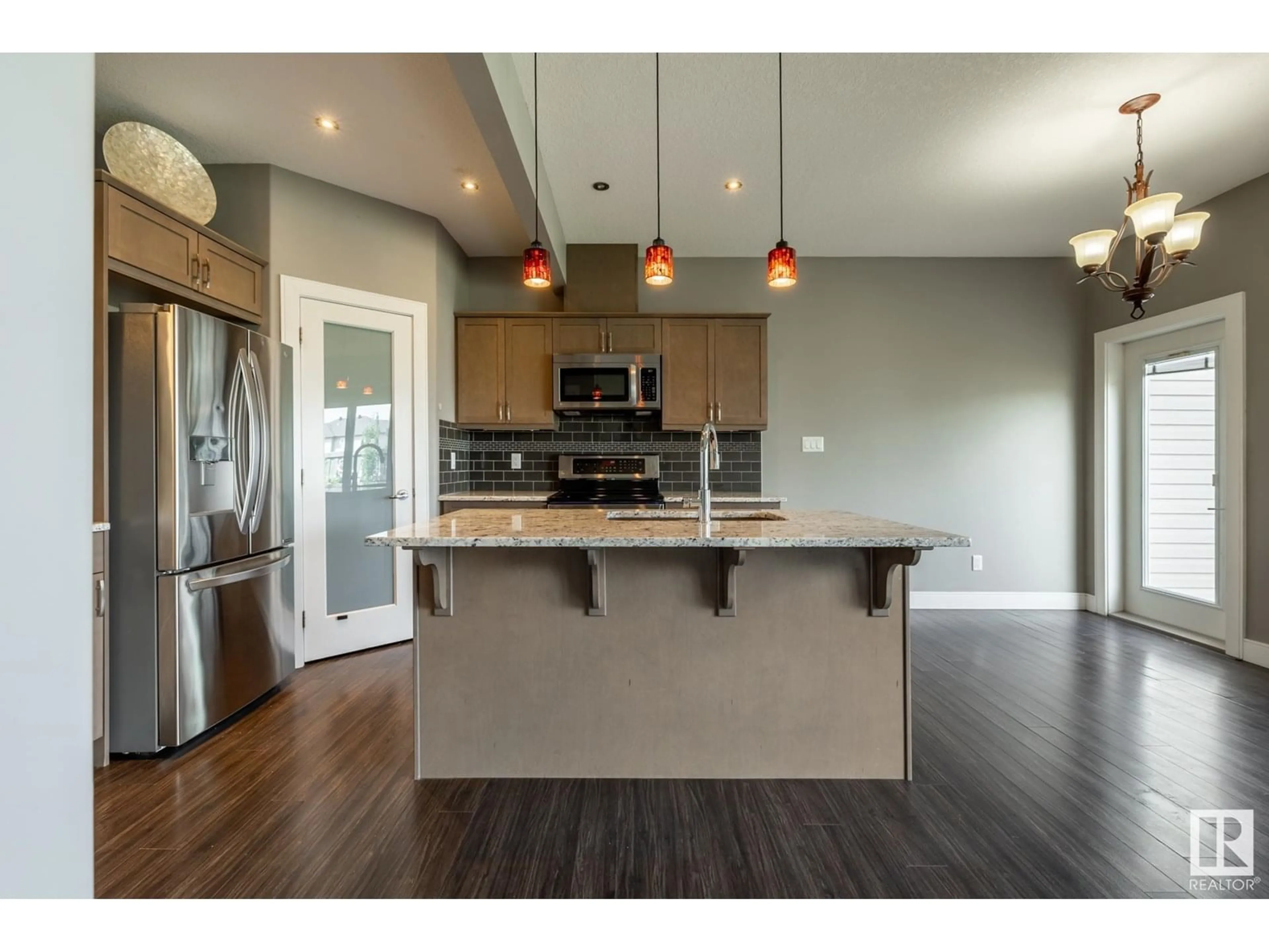 Open concept kitchen, wood/laminate floor for 324 GENESIS VI, Stony Plain Alberta T7Z1A8