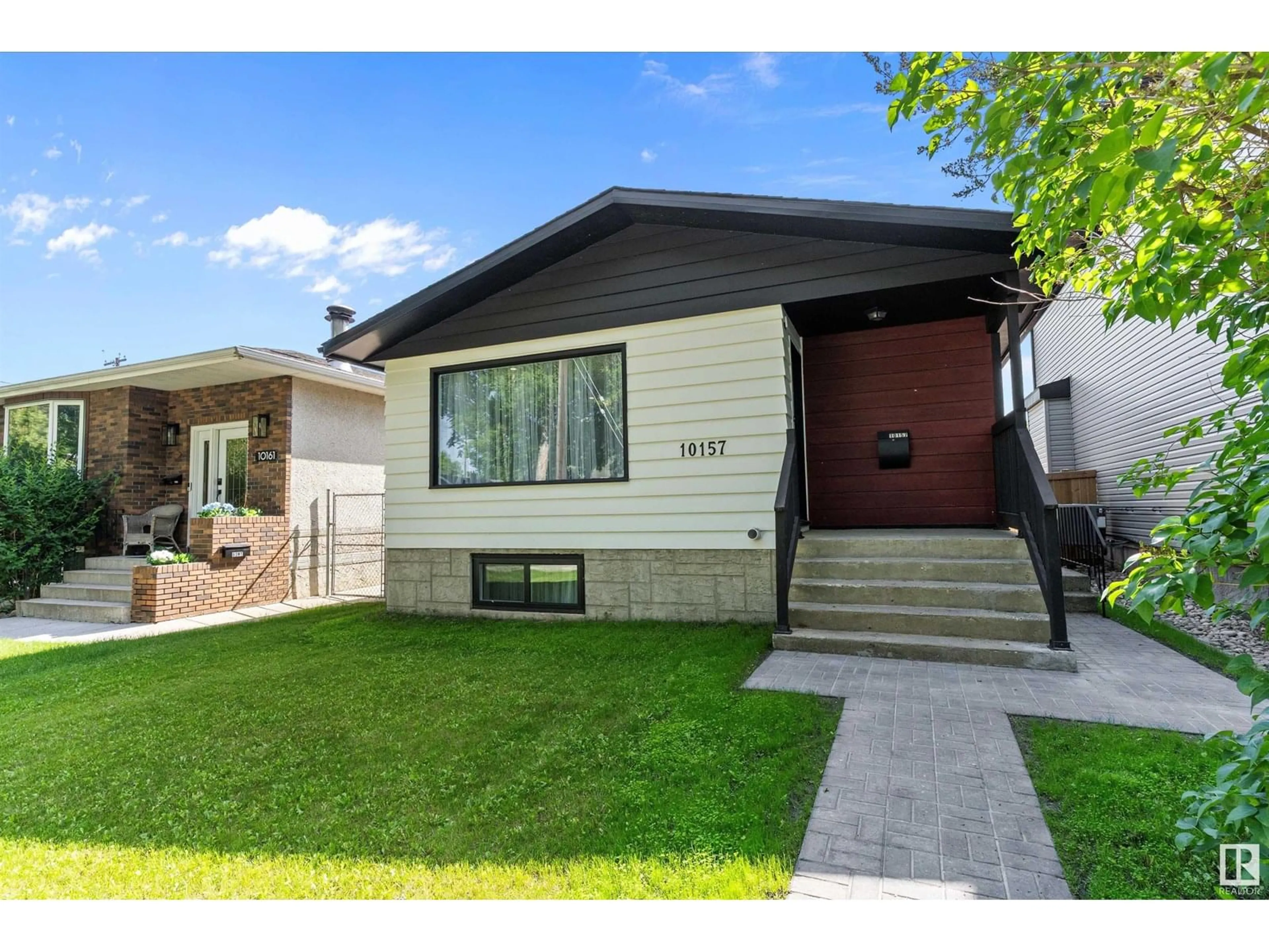 Home with vinyl exterior material, street for NW - 10157 145 ST, Edmonton Alberta T5N2X6