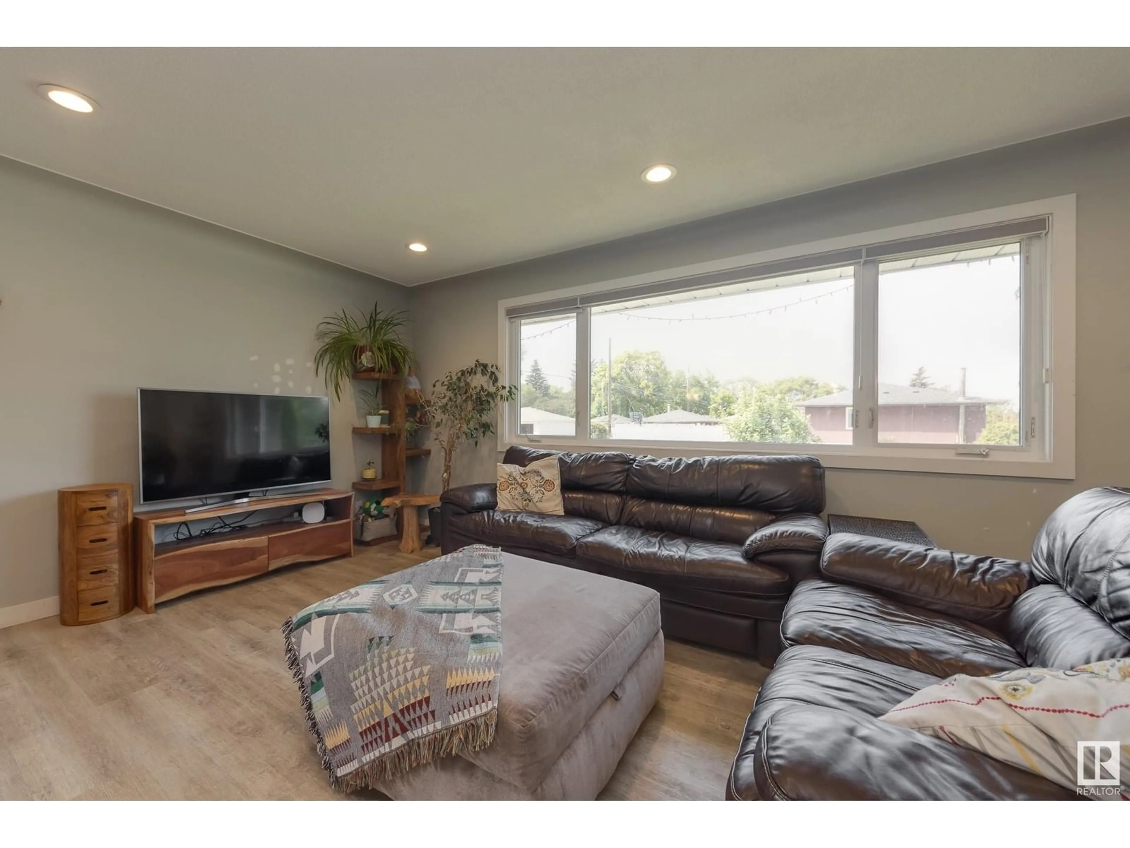 Living room with furniture, wood/laminate floor for 7107 96B AV, Edmonton Alberta T6B1B9