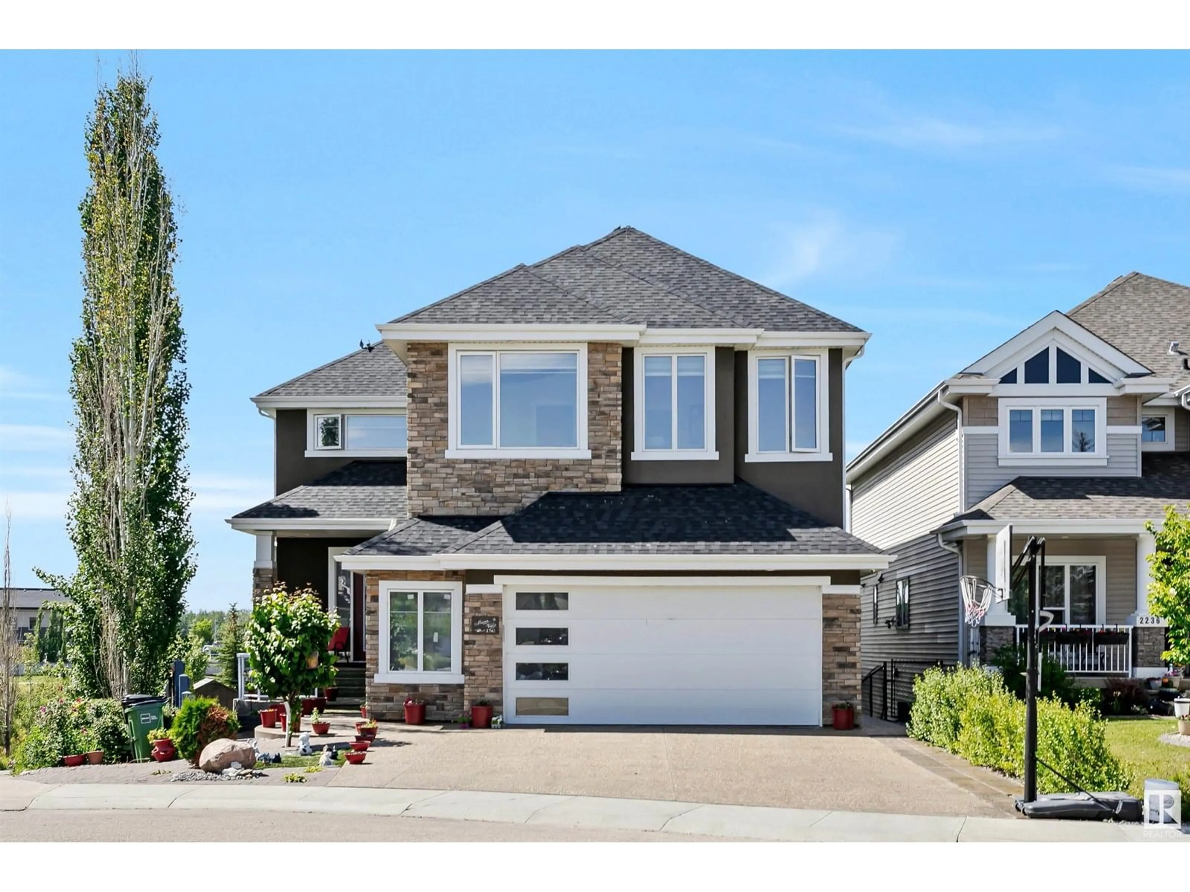 Home with vinyl exterior material, street for 2242 90A ST, Edmonton Alberta T6X0Z9