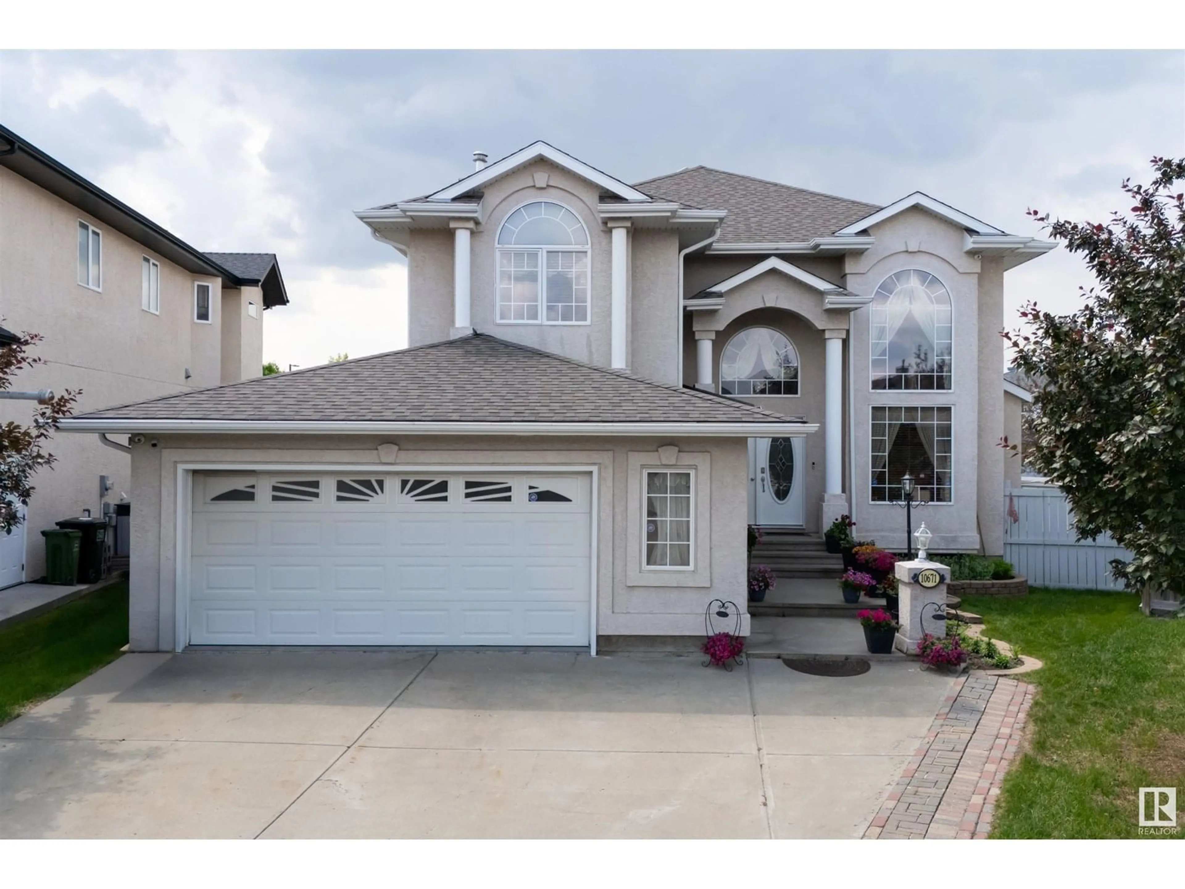 Home with vinyl exterior material, street for 10671 180 AV, Edmonton Alberta T5X6J9