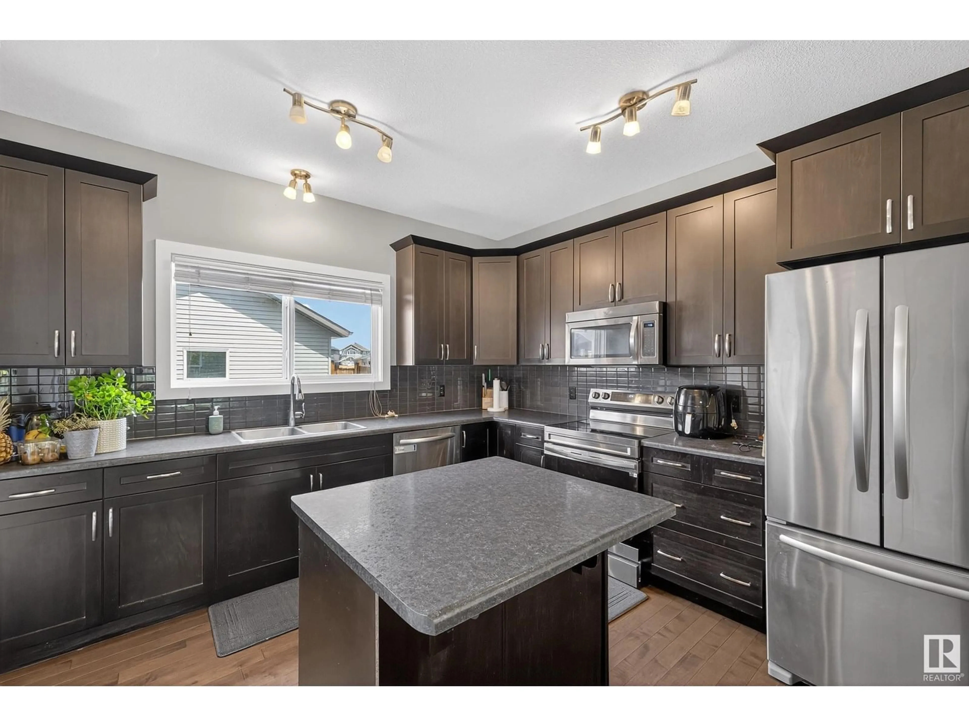 Open concept kitchen, wood/laminate floor for 3112 PAISLEY RD, Edmonton Alberta T6W1A3