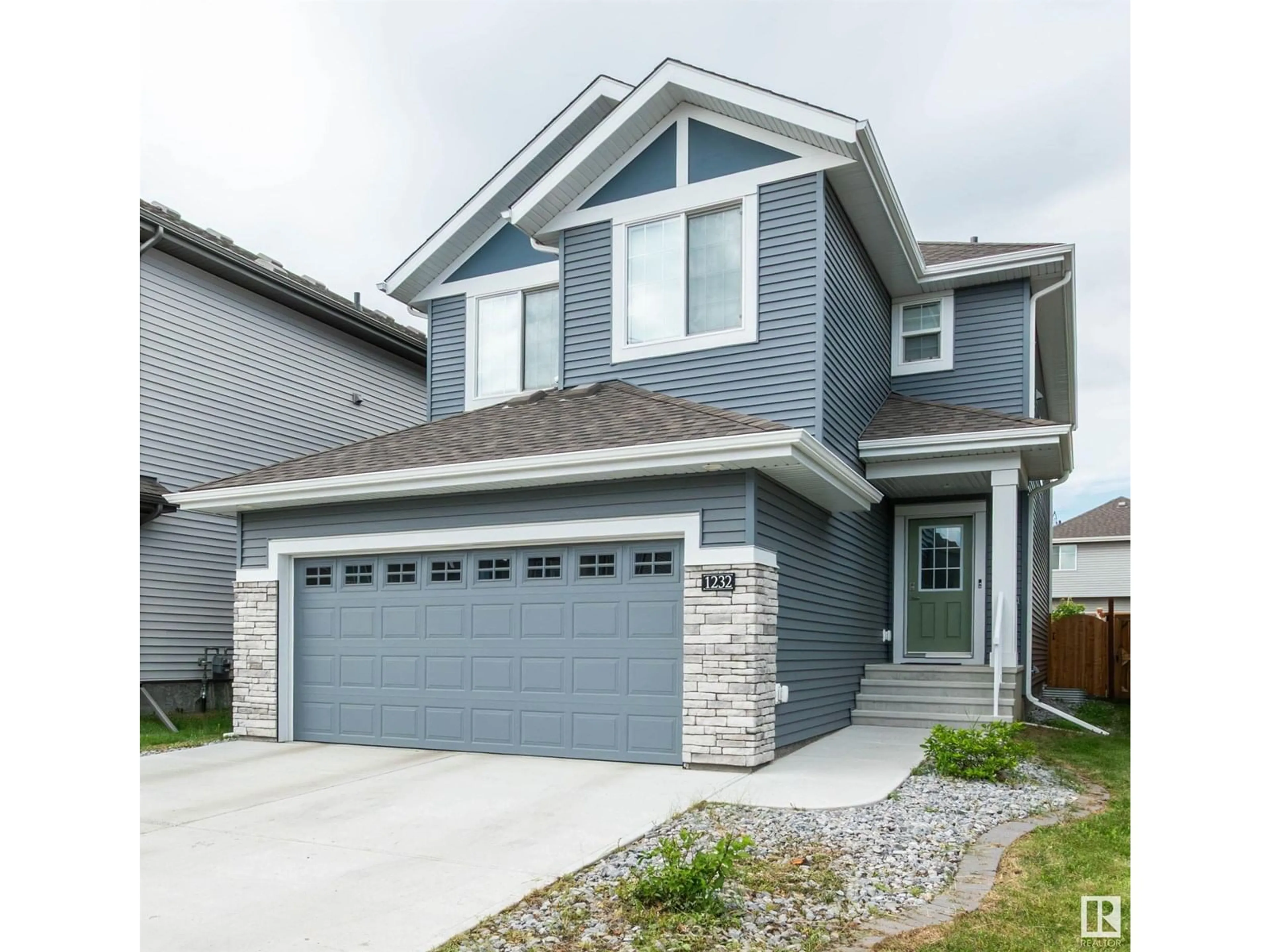 Home with vinyl exterior material, street for 1232 26 ST, Edmonton Alberta T6T2J9