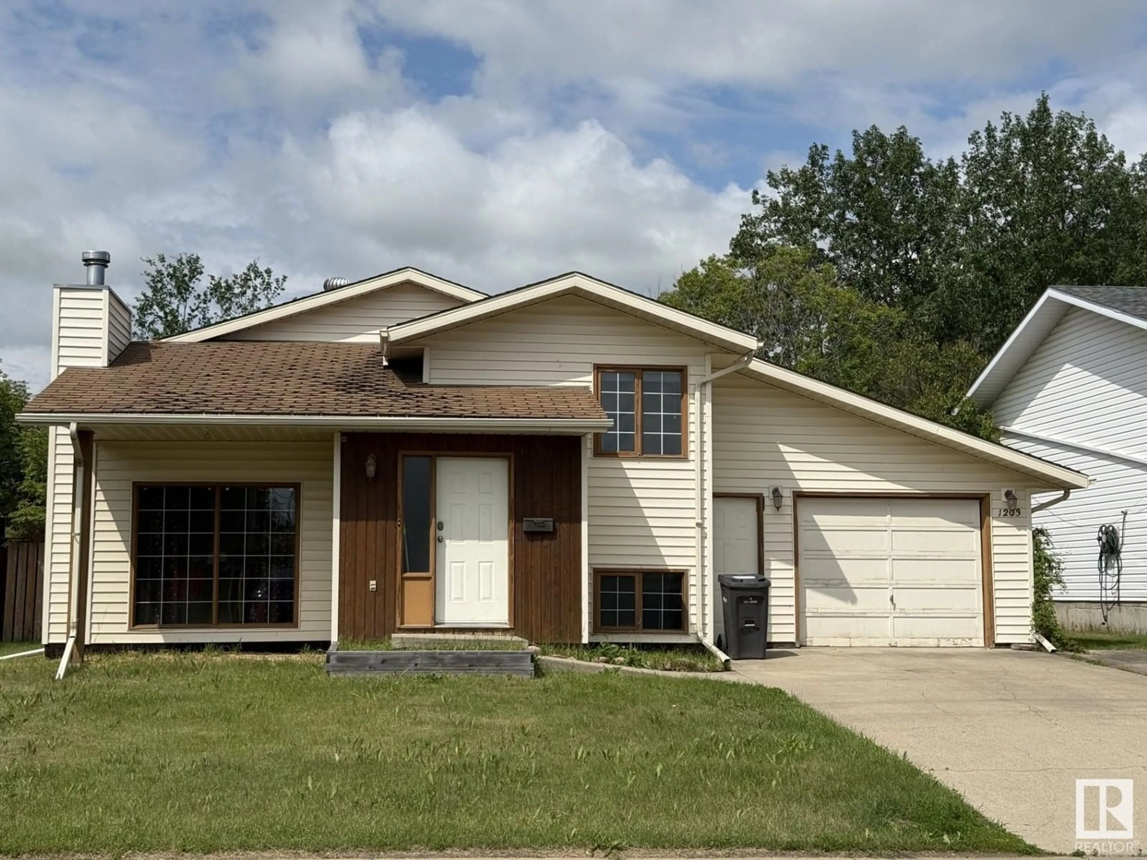 Home with vinyl exterior material, street for 1203 12 ST, Cold Lake Alberta T9M1J4