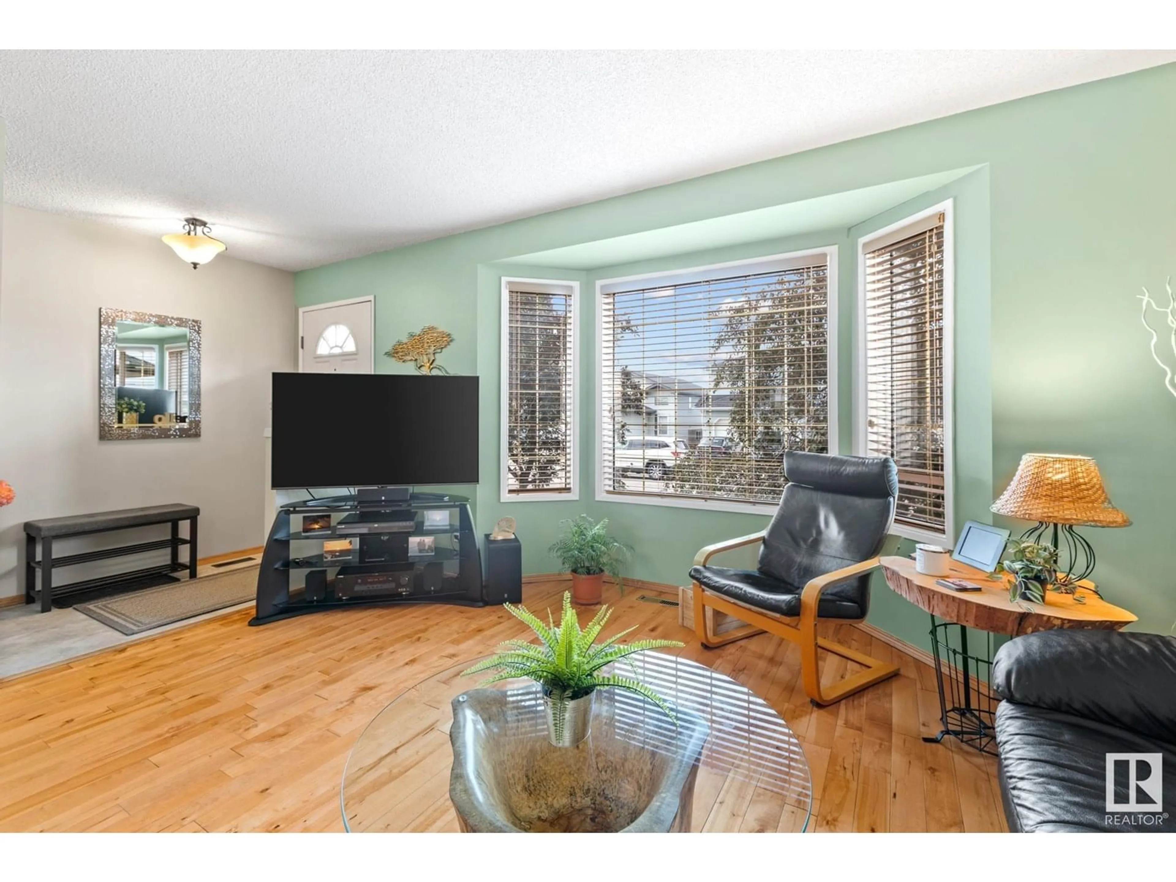 Living room with furniture, wood/laminate floor for NW - 5827 162B AV, Edmonton Alberta T5Y2W3