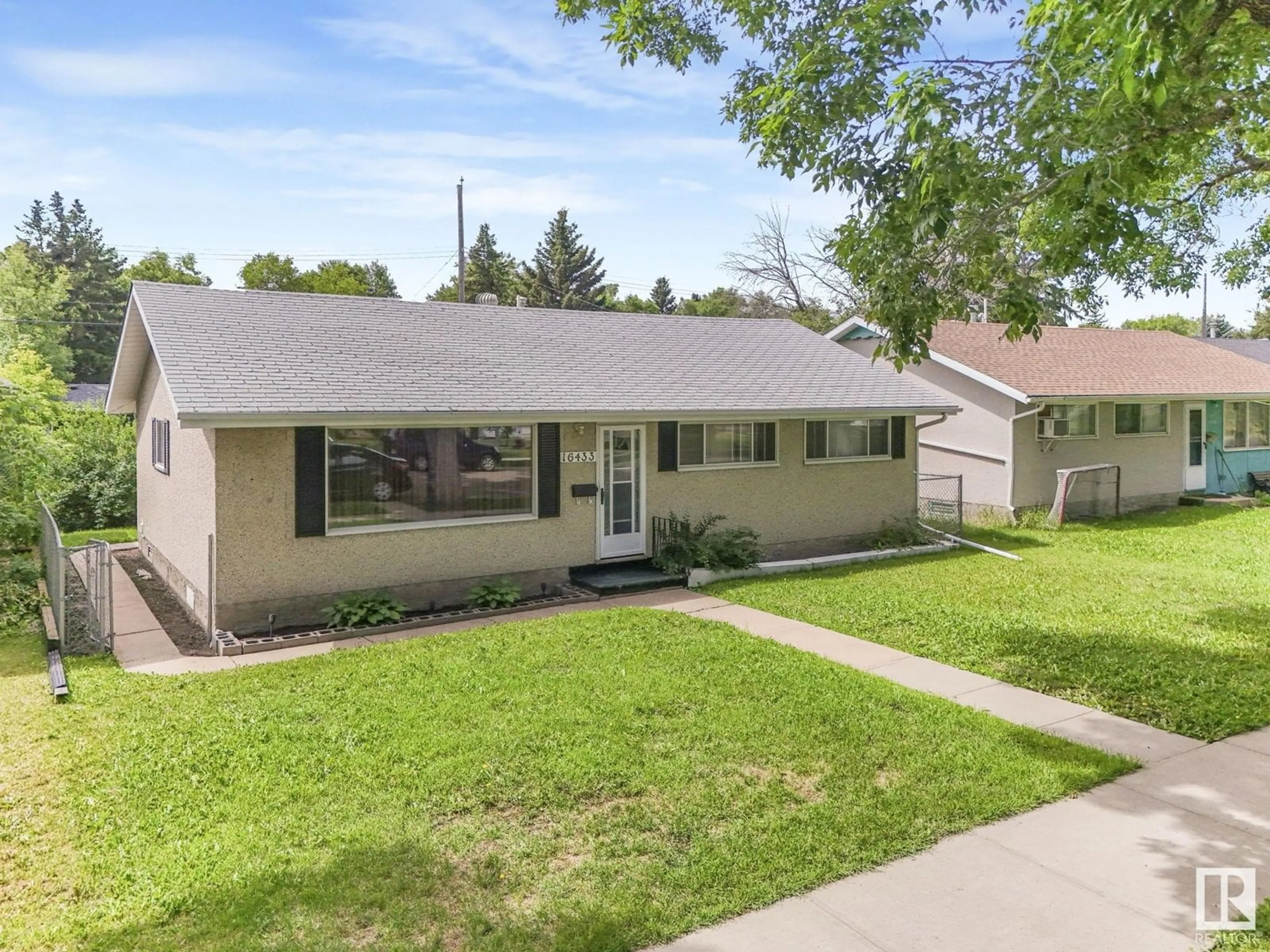 Home with vinyl exterior material, street for 16433 106 AV, Edmonton Alberta T5X0X1
