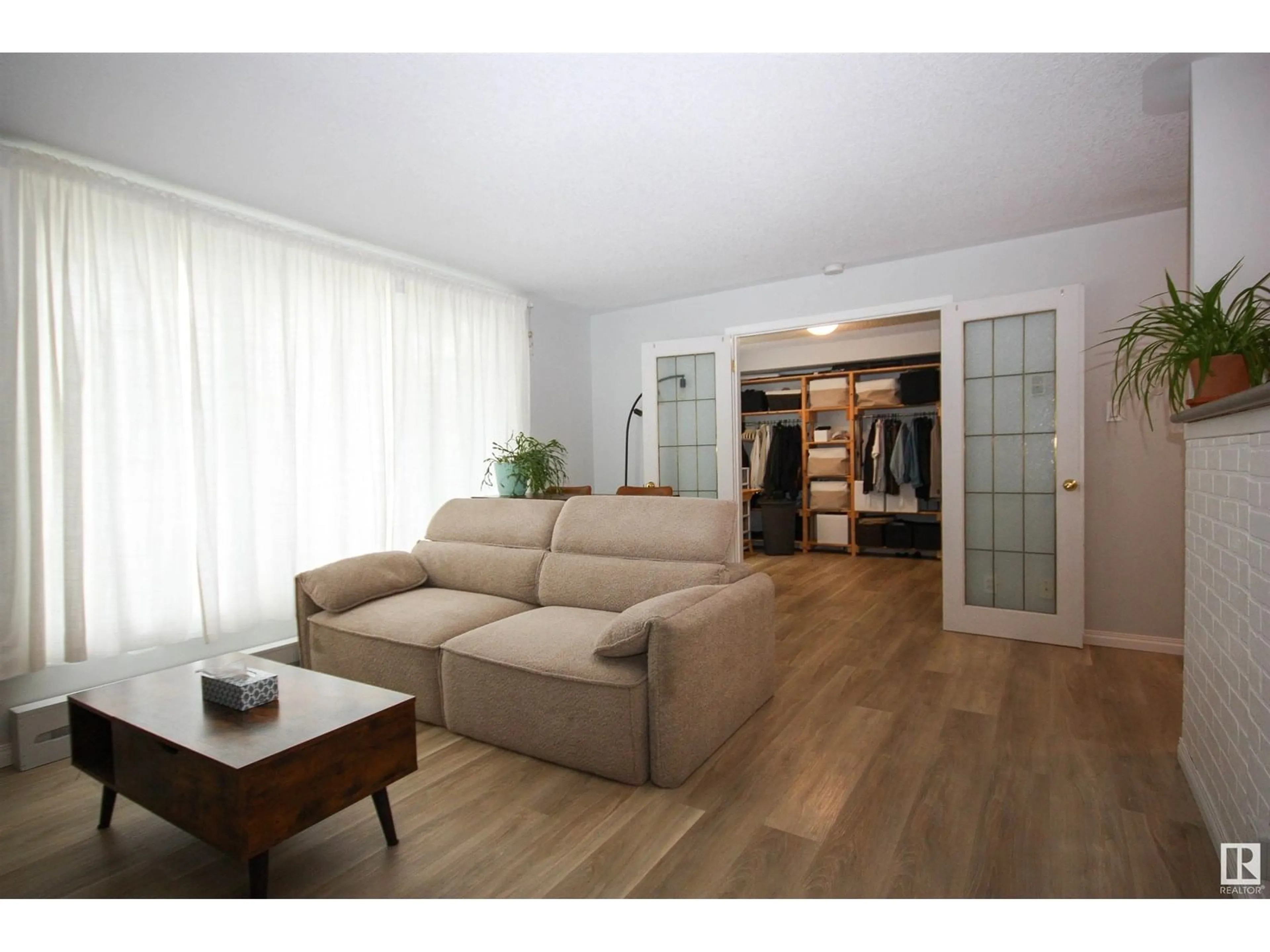 Living room with furniture, wood/laminate floor for 11008 124 ST, Edmonton Alberta T5M0J4