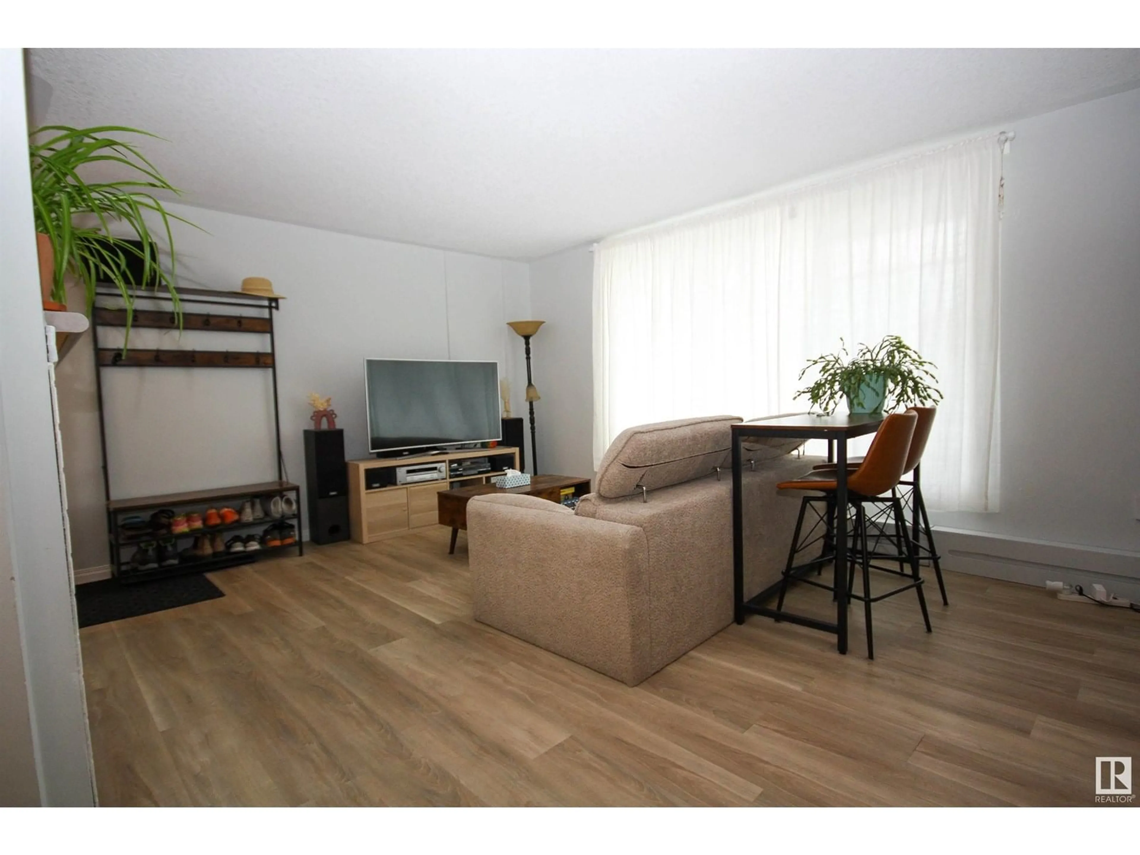 Living room with furniture, wood/laminate floor for 11008 124 ST, Edmonton Alberta T5M0J4
