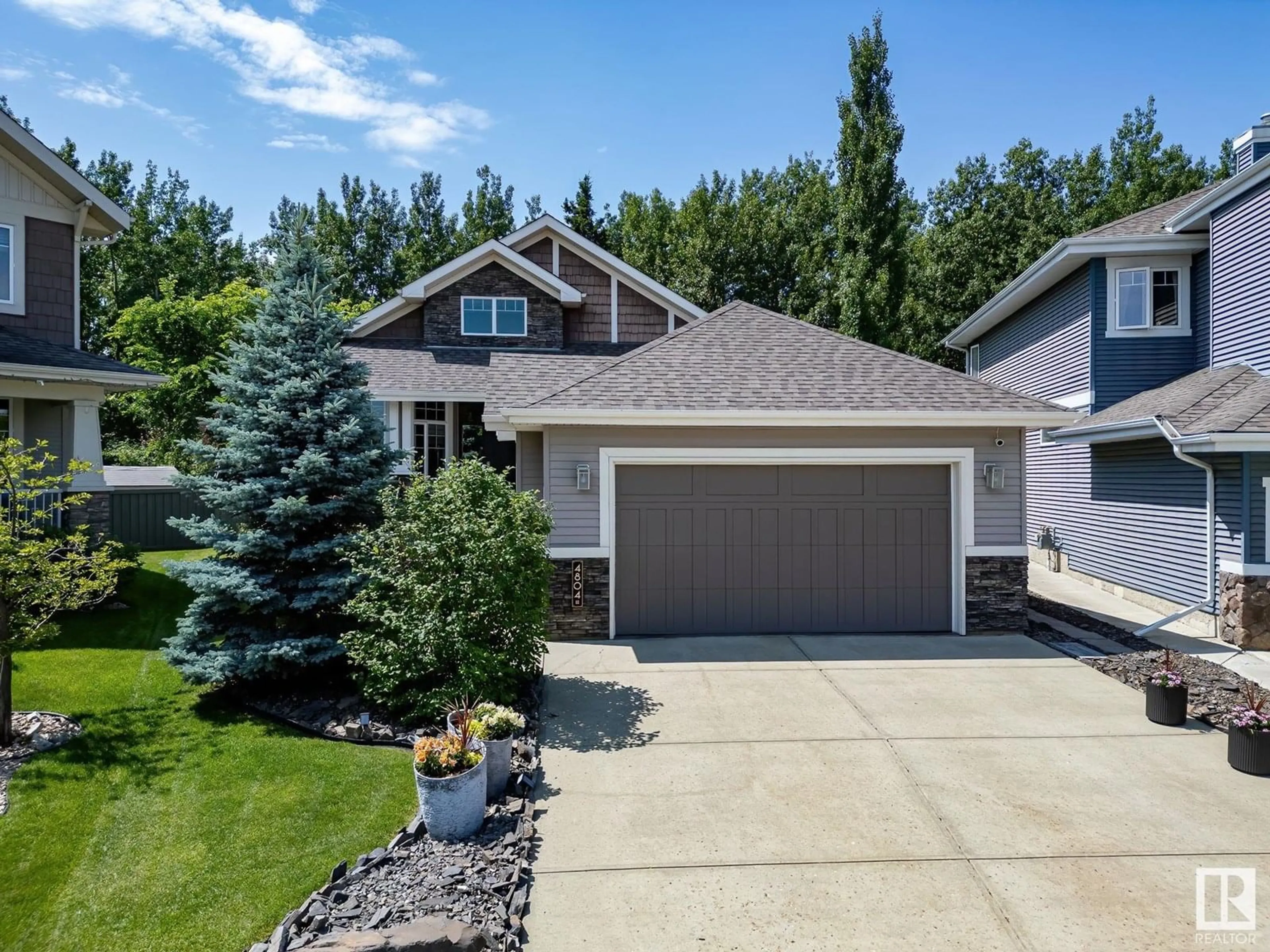 Home with vinyl exterior material, street for 4804 212 ST NW, Edmonton Alberta T6M0G2