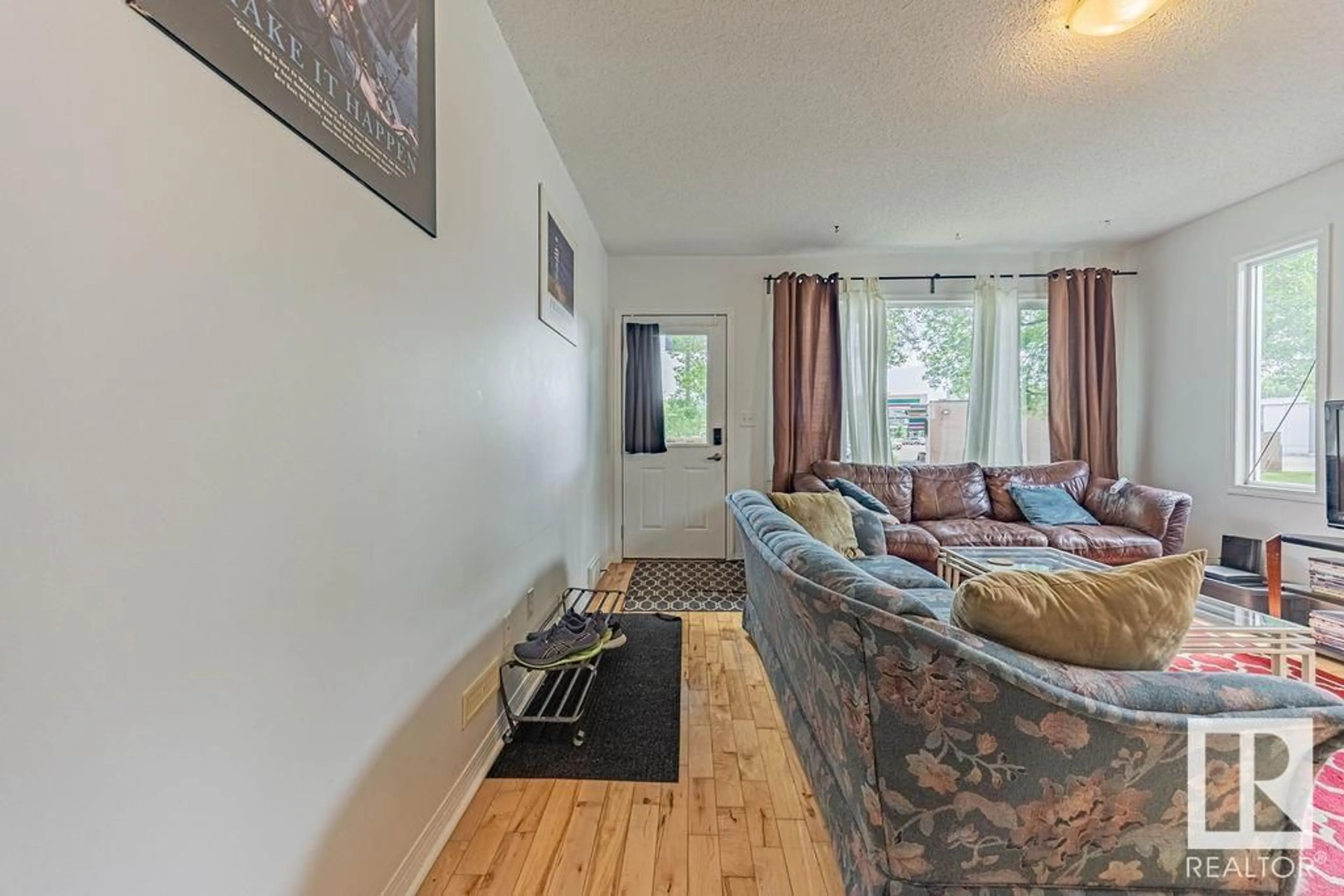 Living room with furniture, wood/laminate floor for 11606 67 ST, Edmonton Alberta T5B1L8