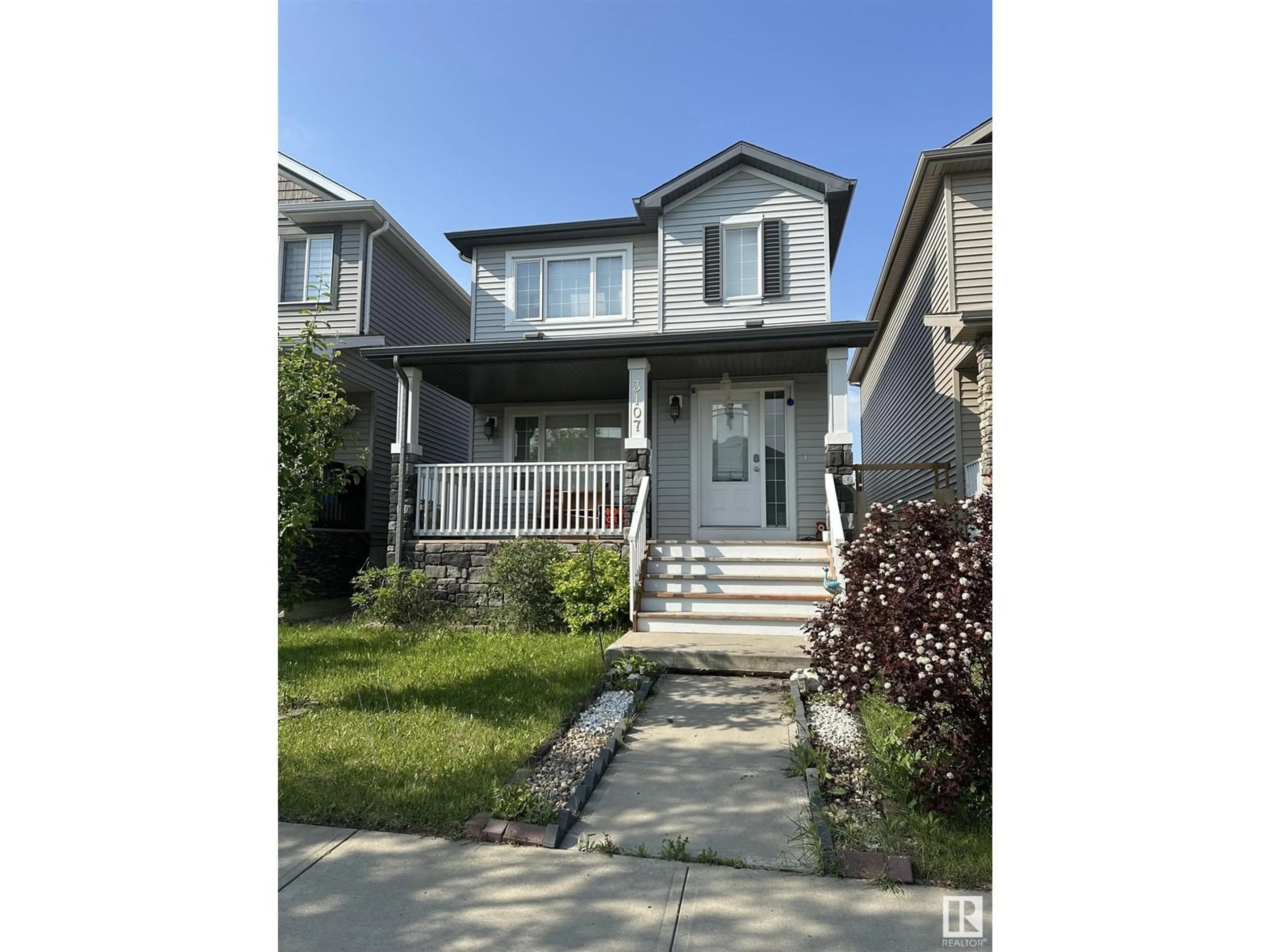 Home with vinyl exterior material, street for 3107 14 AV, Edmonton Alberta T6T0Z2