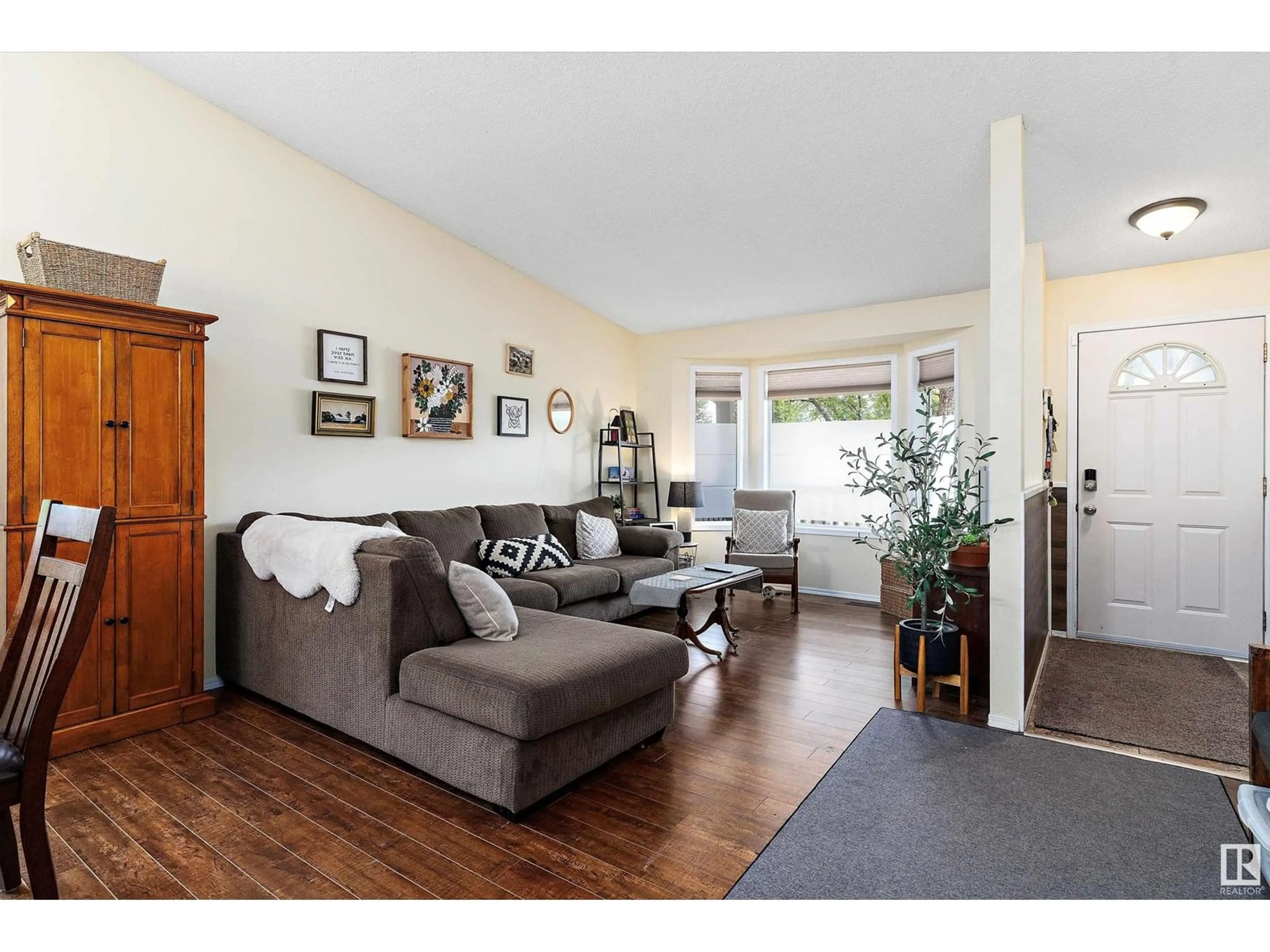 Living room with furniture, wood/laminate floor for 11108 10A AV, Edmonton Alberta T6J6S8