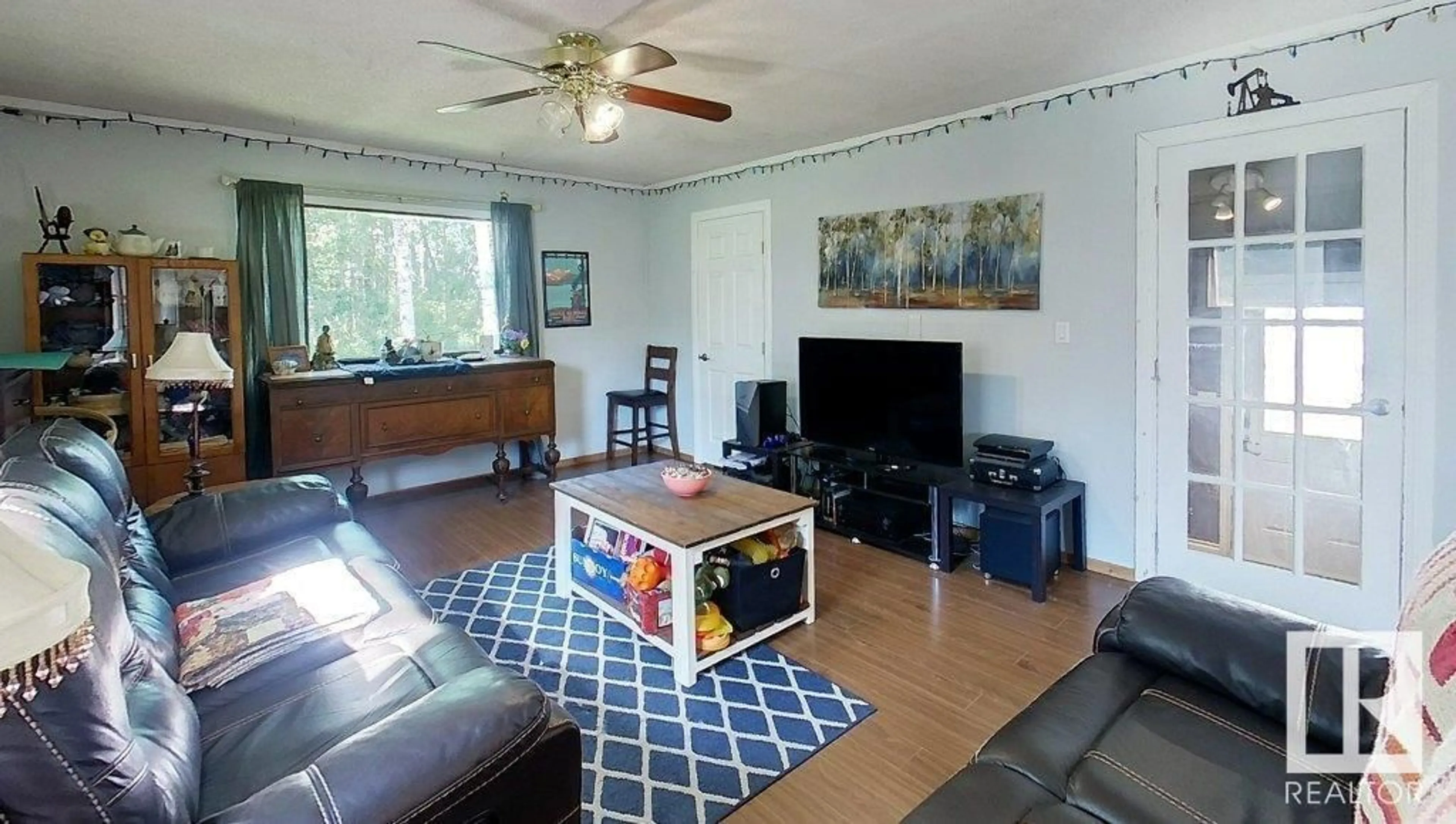 Living room with furniture, wood/laminate floor for 53516 RANGE ROAD 154, Rural Yellowhead Alberta T7E3G9