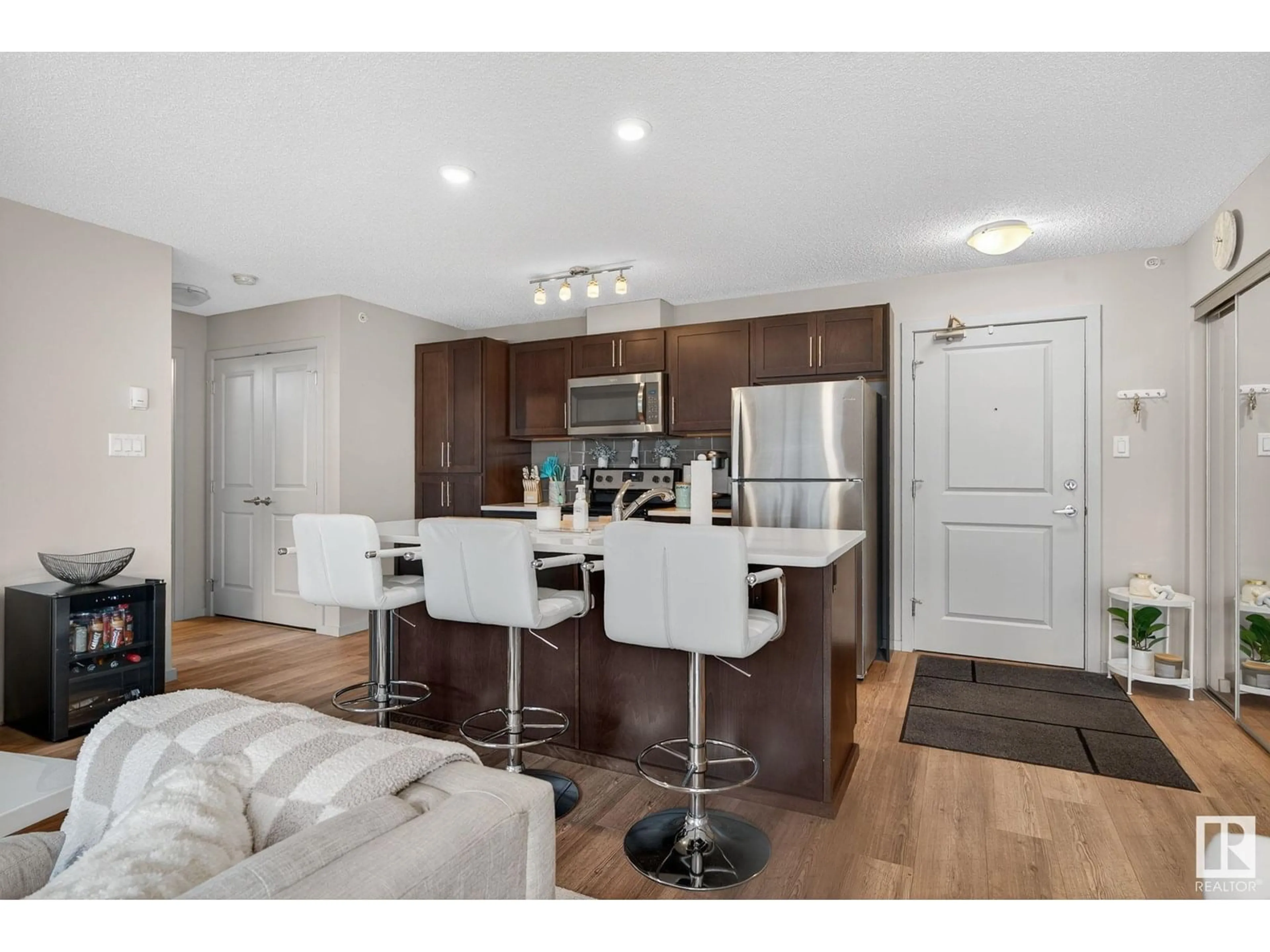 Open concept kitchen, wood/laminate floor for #409 - 5404 7 AV SW, Edmonton Alberta T6X2K4