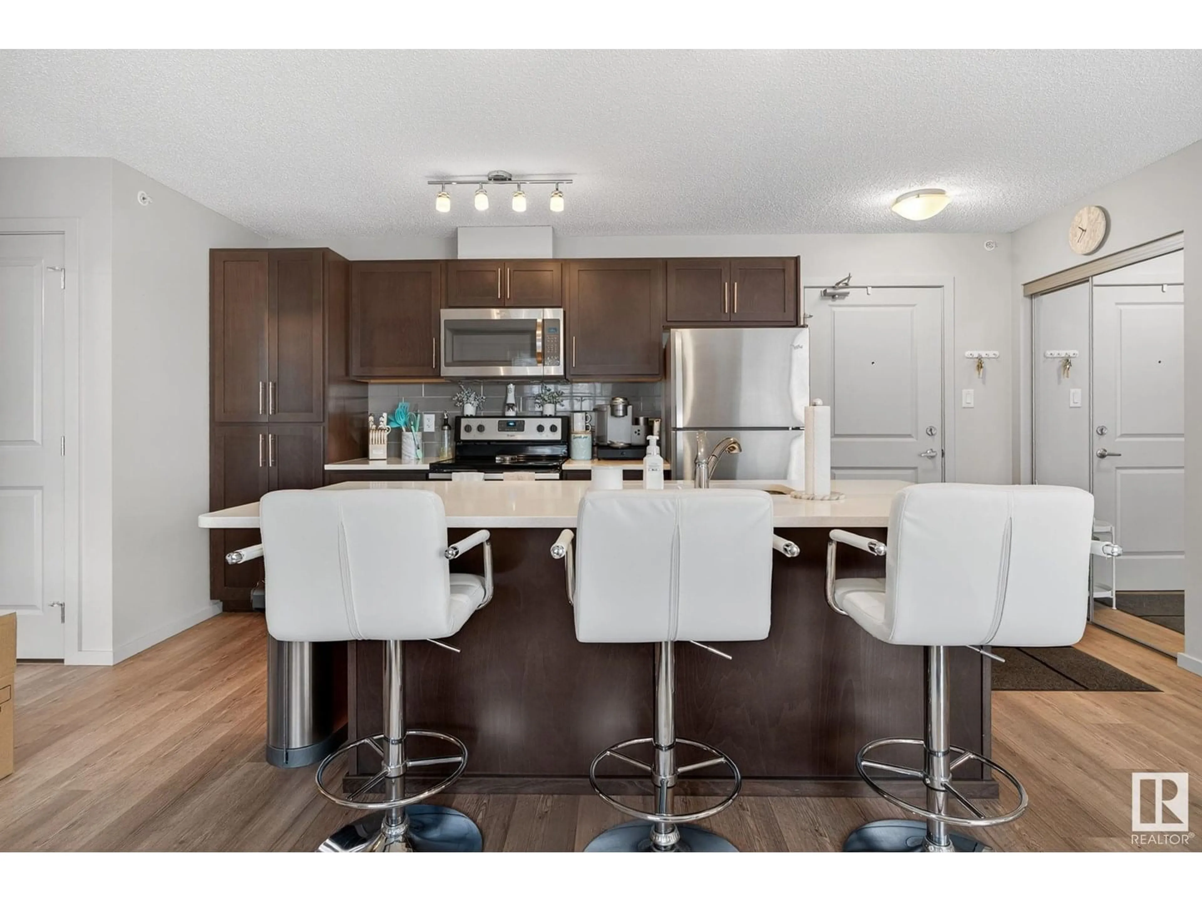 Open concept kitchen, wood/laminate floor for #409 - 5404 7 AV SW, Edmonton Alberta T6X2K4