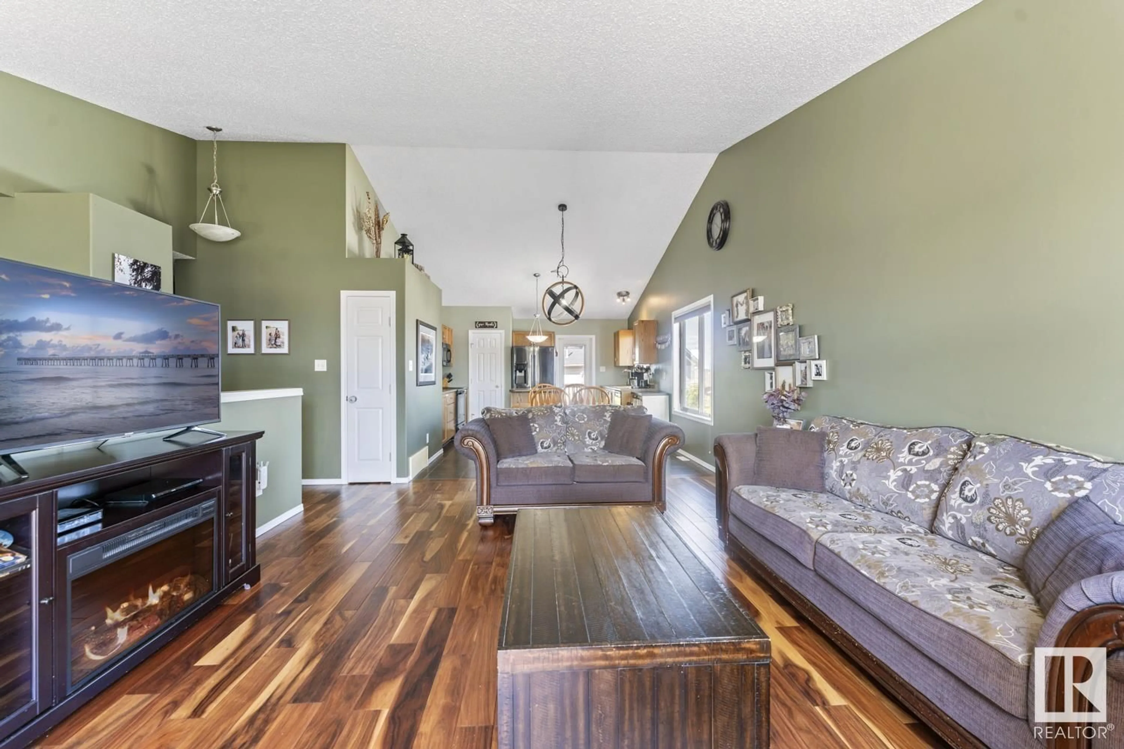 Living room with furniture, wood/laminate floor for 703 SPARROW CL, Cold Lake Alberta T9M2B7