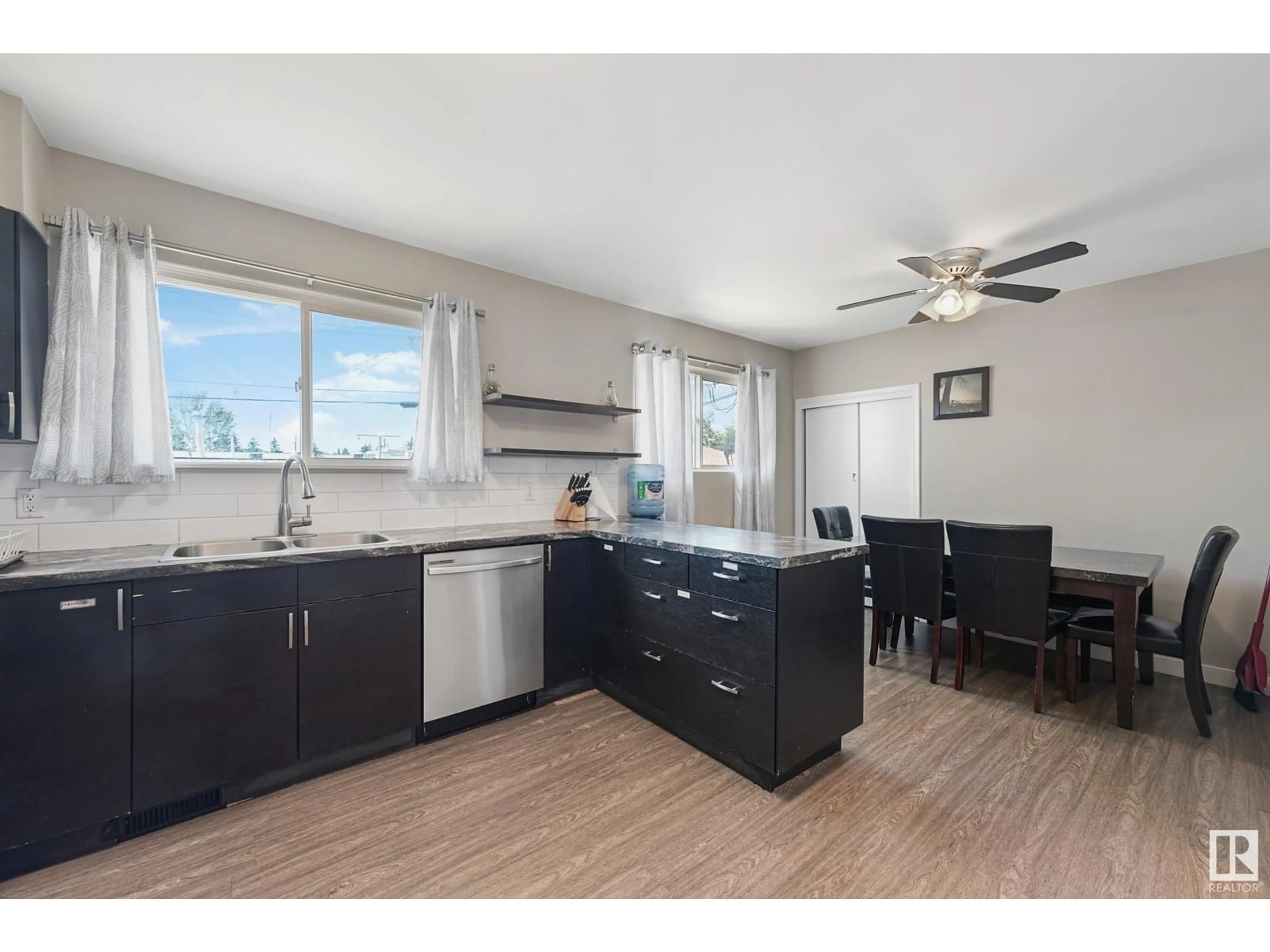 Open concept kitchen, wood/laminate floor for 12926 96 ST, Edmonton Alberta T5E4B1