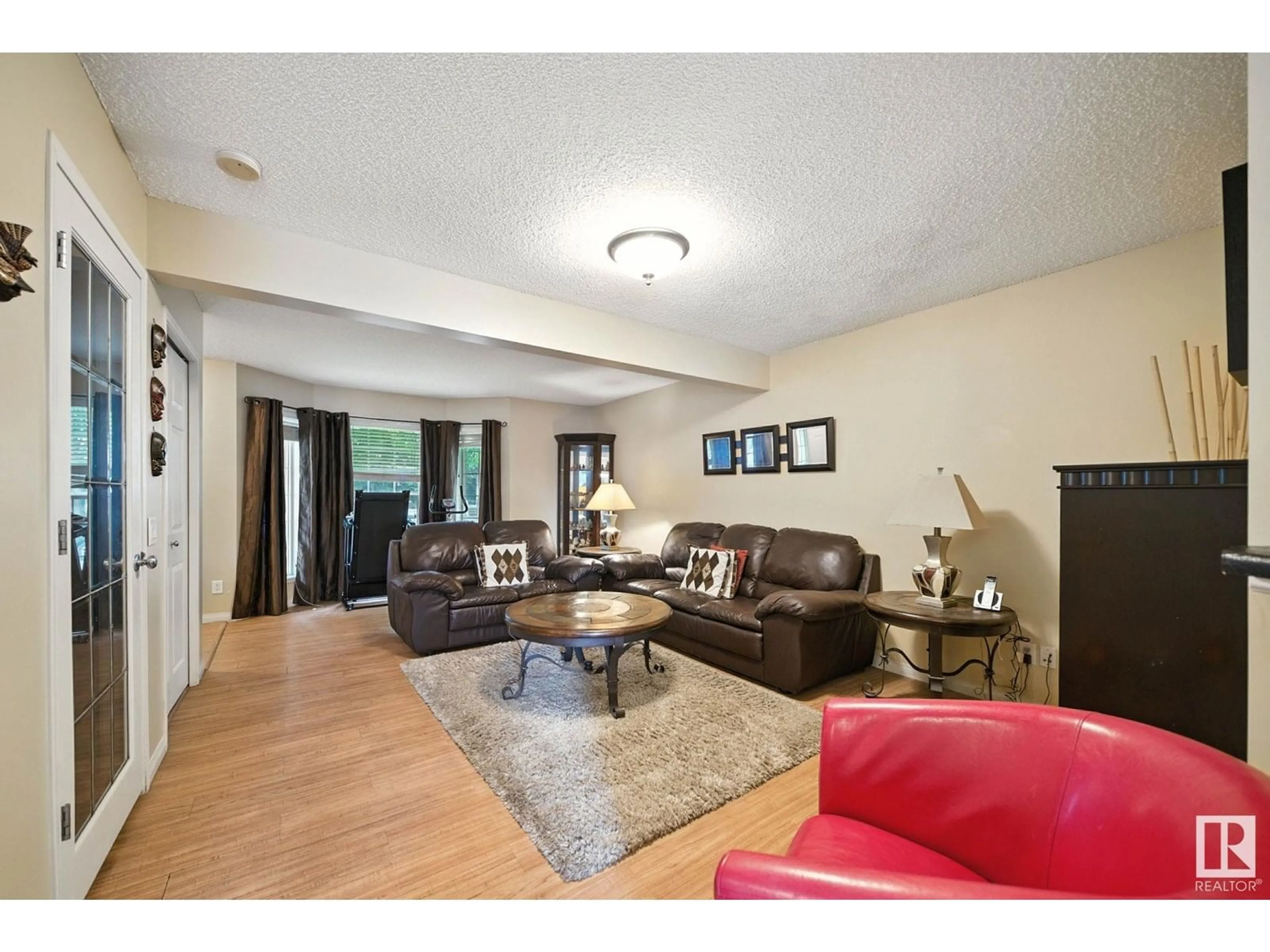 Living room with furniture, wood/laminate floor for 4218 TERWILLEGAR VISTA VS, Edmonton Alberta T6R3E2