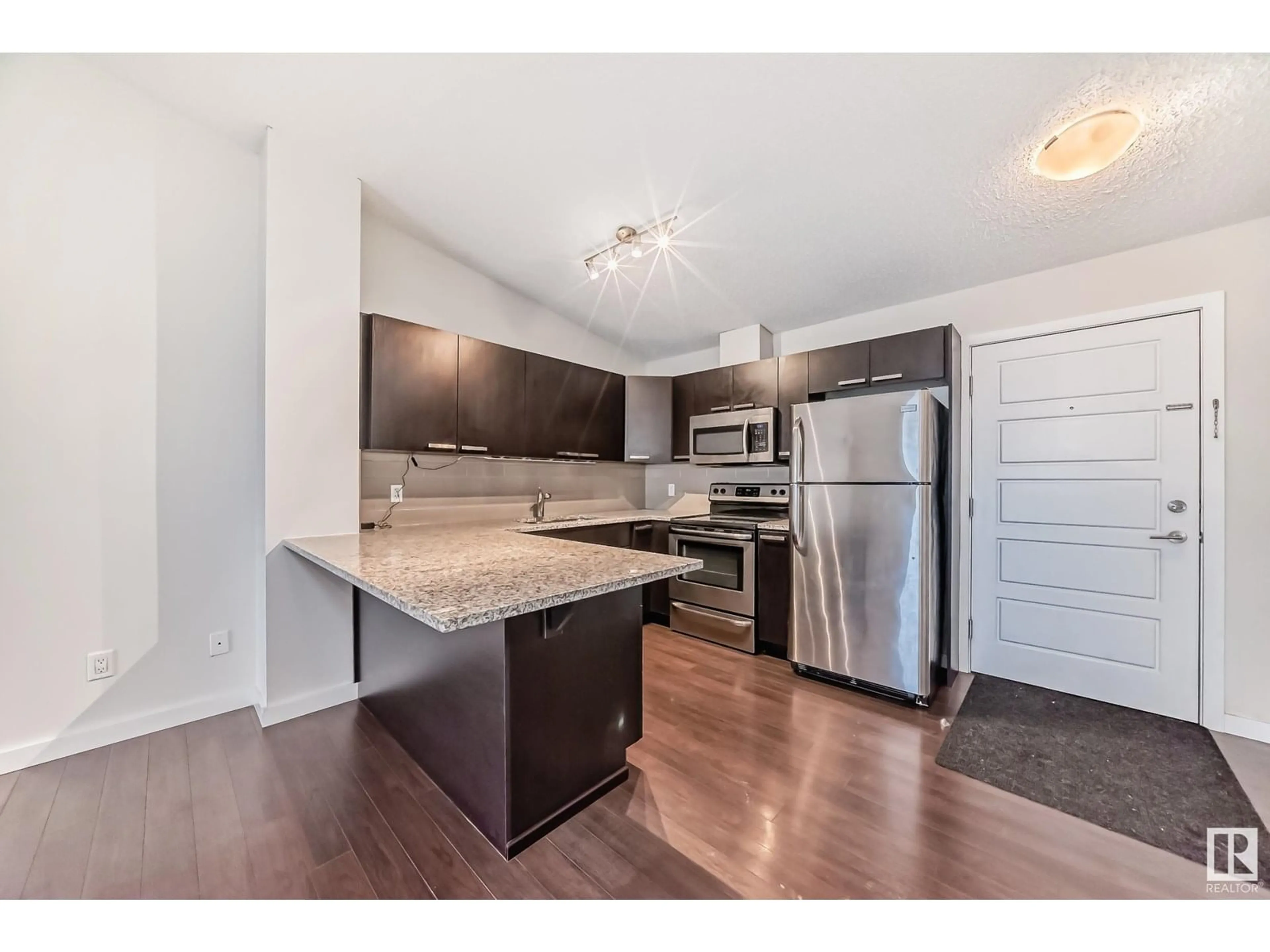 Open concept kitchen, wood/laminate floor for #406 - 14808 125 ST, Edmonton Alberta T5X0G1