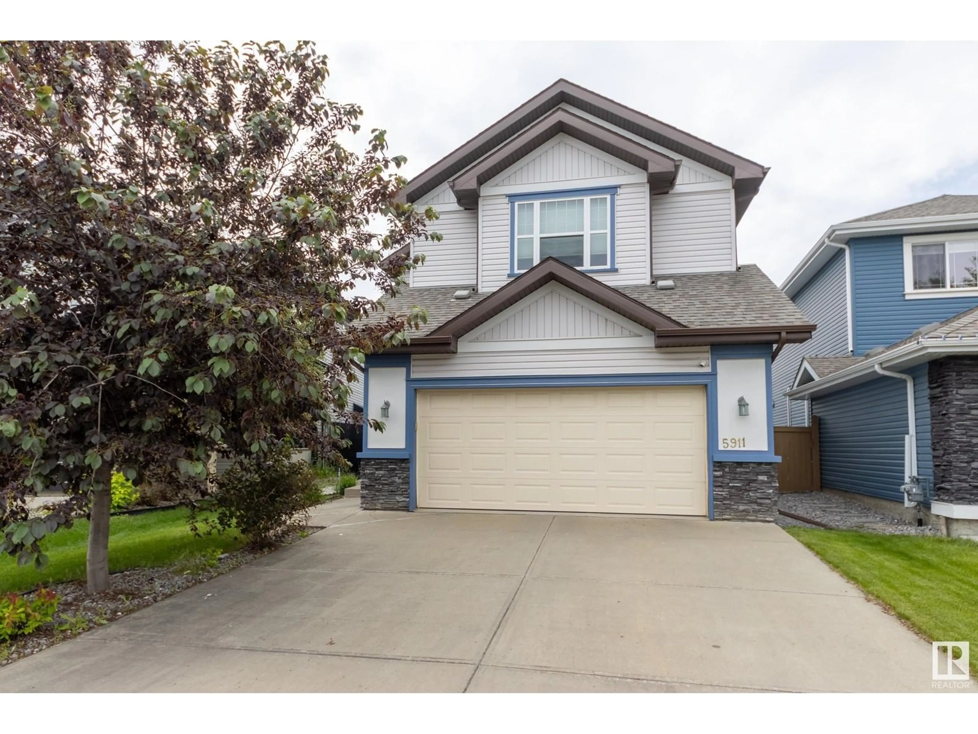 Home with vinyl exterior material, street for 5911 168 AV, Edmonton Alberta T5Y0P4