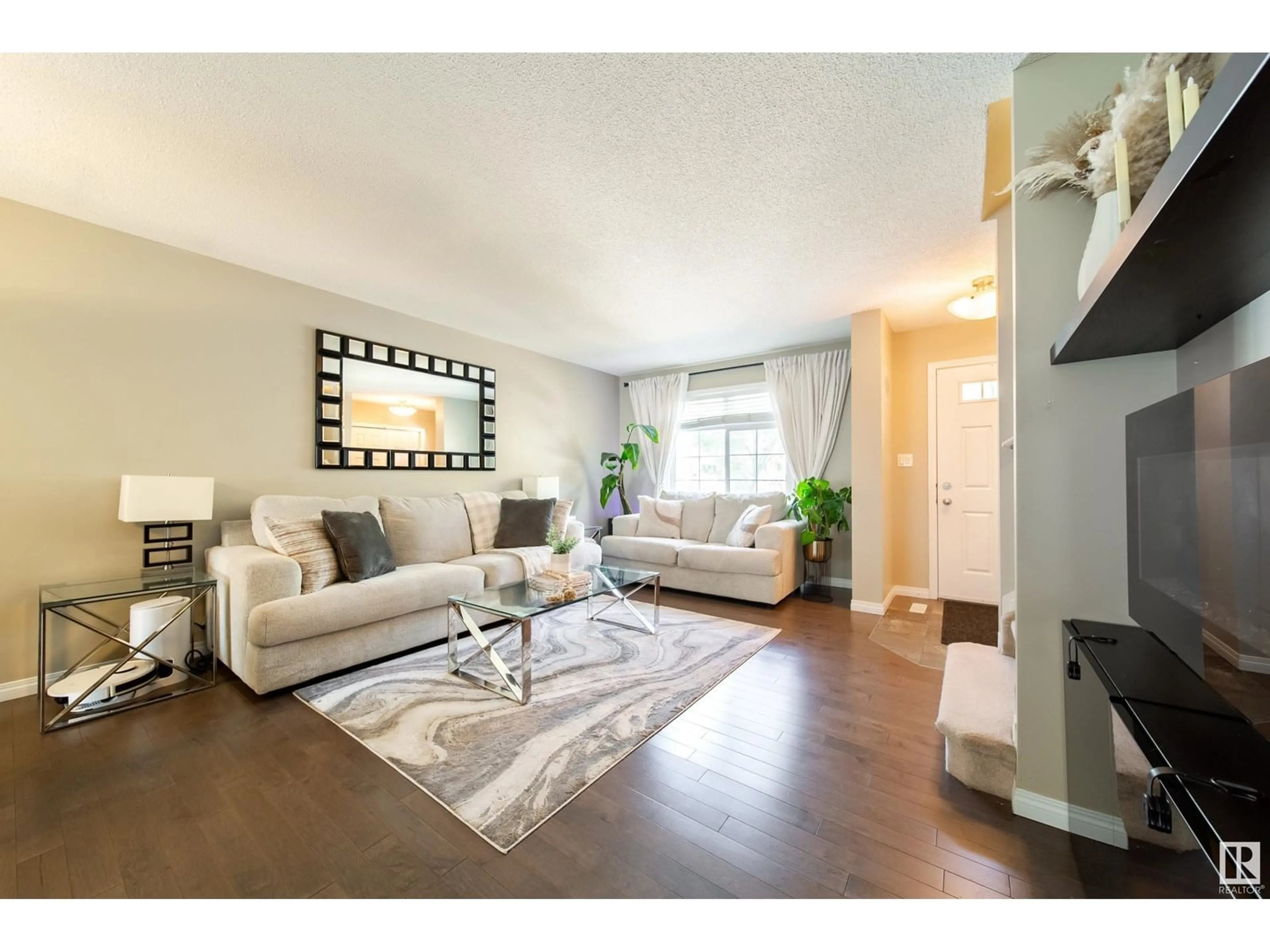 Living room with furniture, wood/laminate floor for 9151 - 25 SHAW WY, Edmonton Alberta T6X1W7