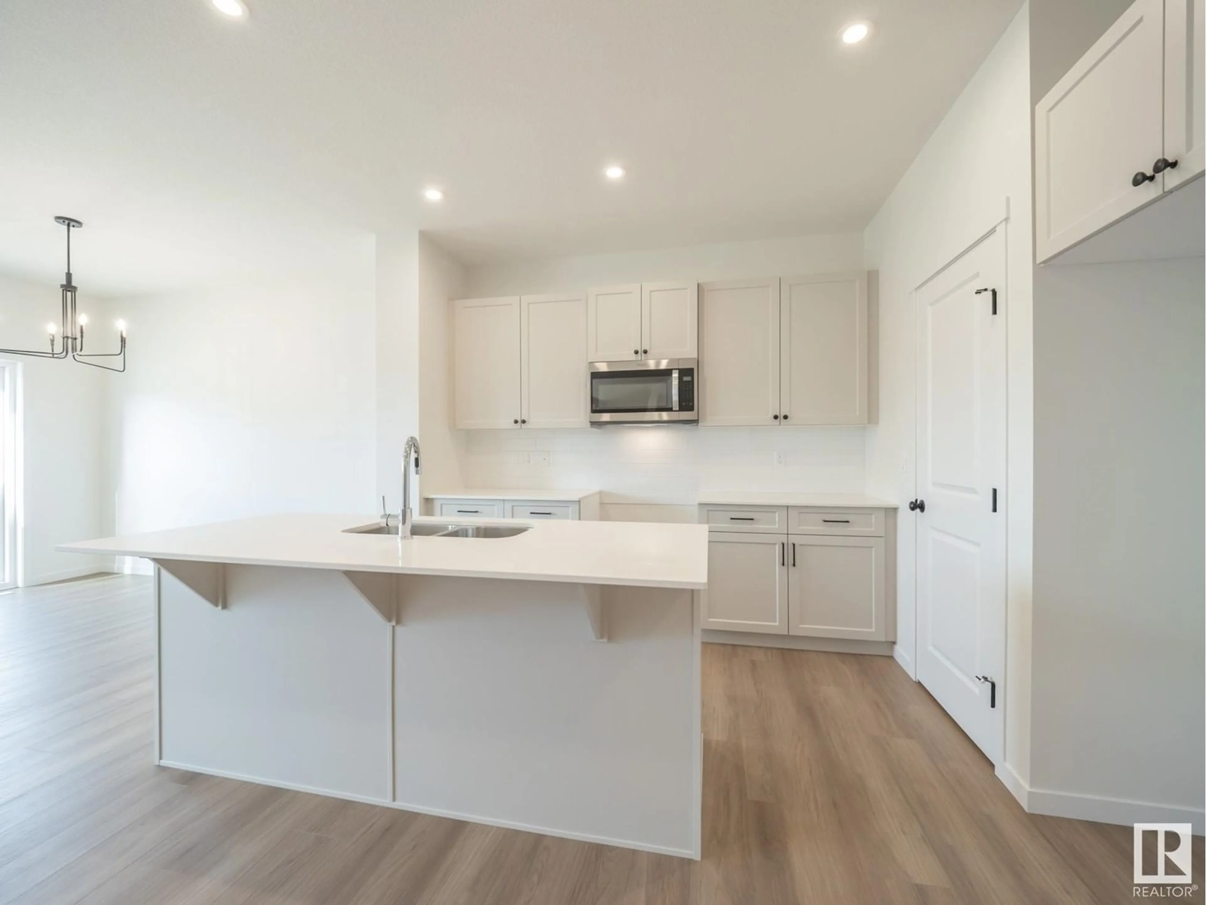 Open concept kitchen, wood/laminate floor for NW - 22403 90 AV, Edmonton Alberta T5T7X2
