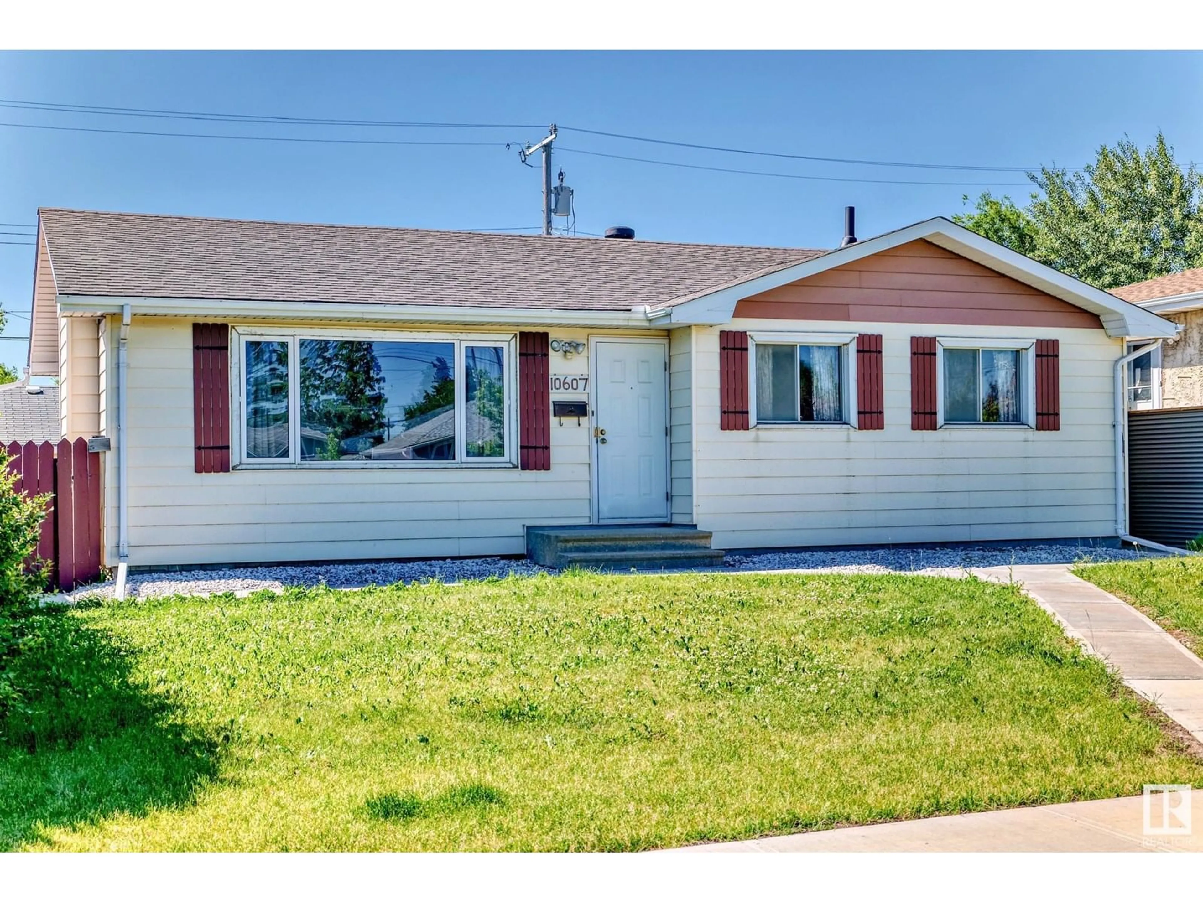 Home with vinyl exterior material, street for 10607 132 AV, Edmonton Alberta T5E0Z3