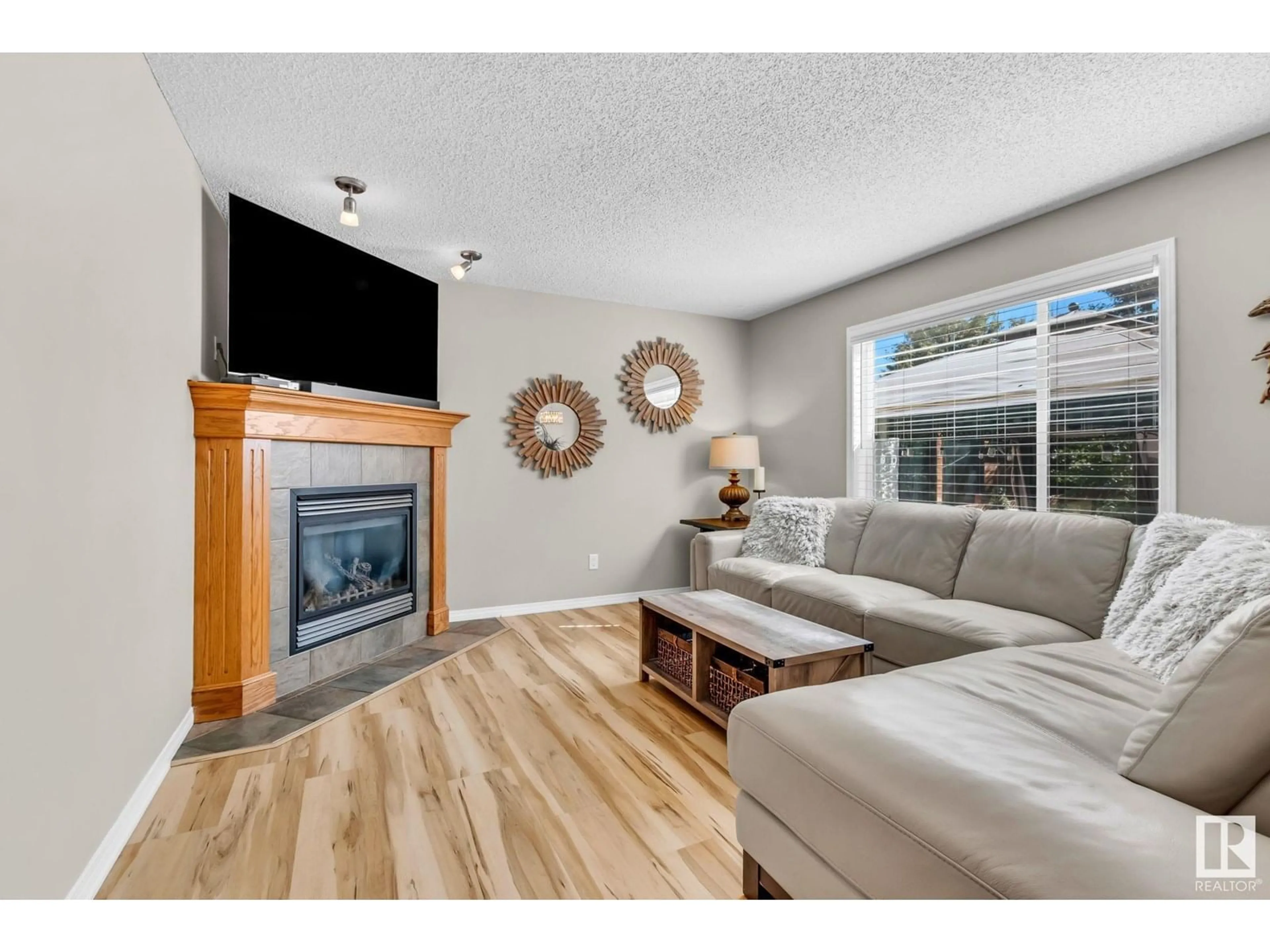 Living room with furniture, wood/laminate floor for 303 SOUTHWICK BV, Leduc Alberta T9E0E8